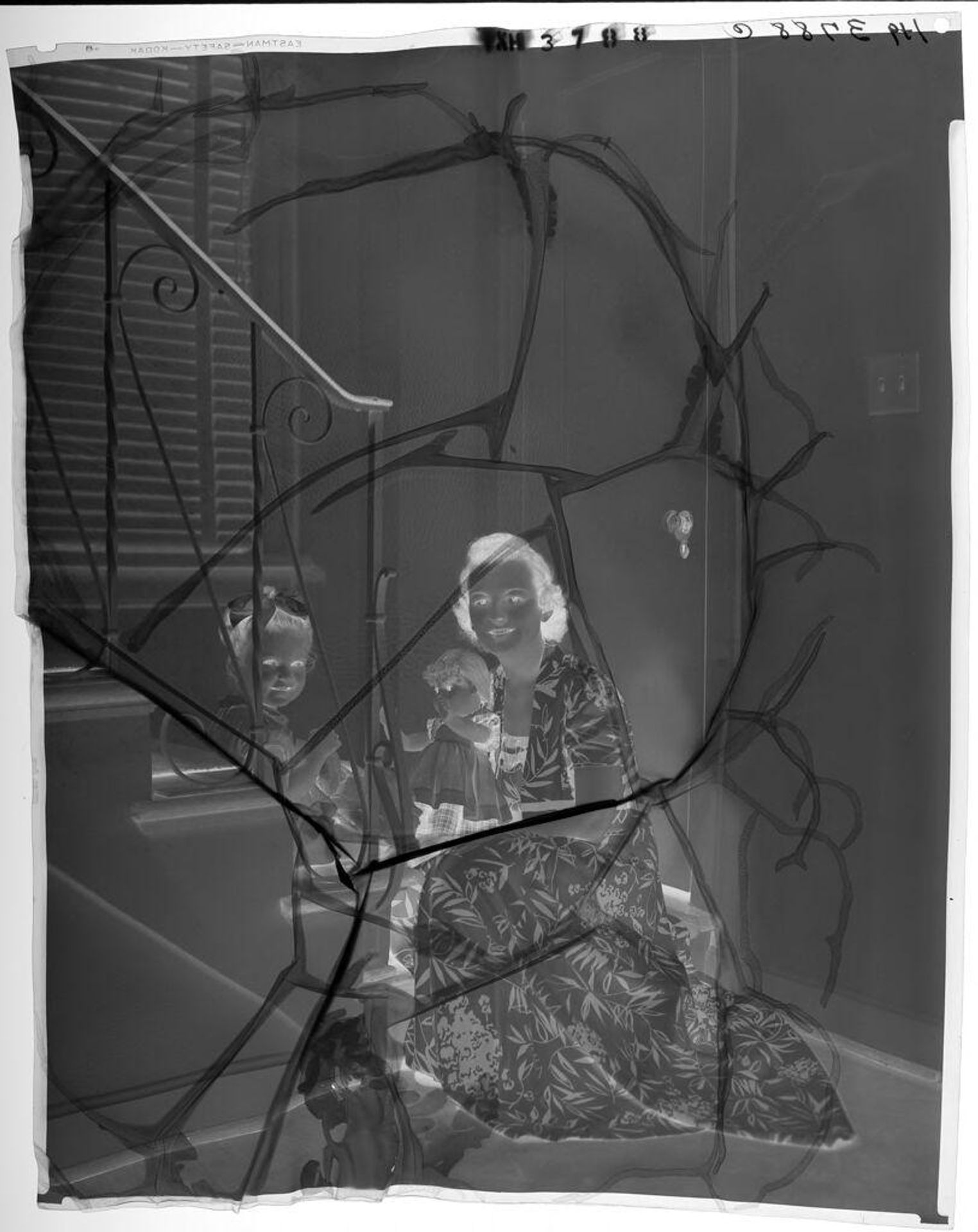 Untitled (woman seated on staircase with little girl and doll) by Paul Gittings