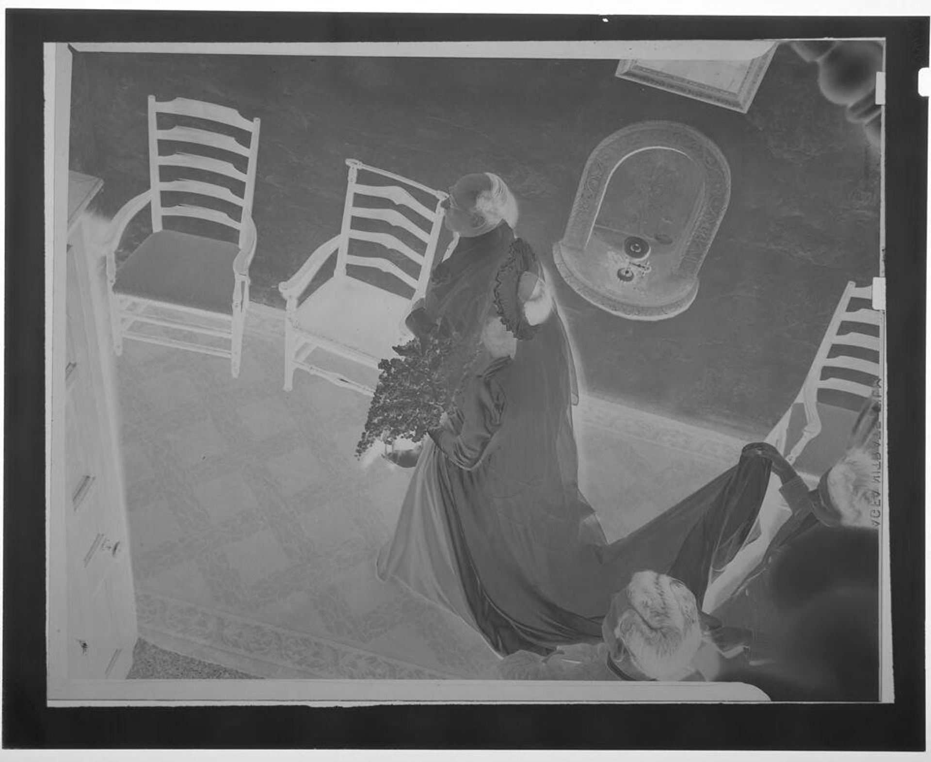 Untitled (overhead view of man walking bride down aisle with woman holding up dress in back) by Martin Schweig