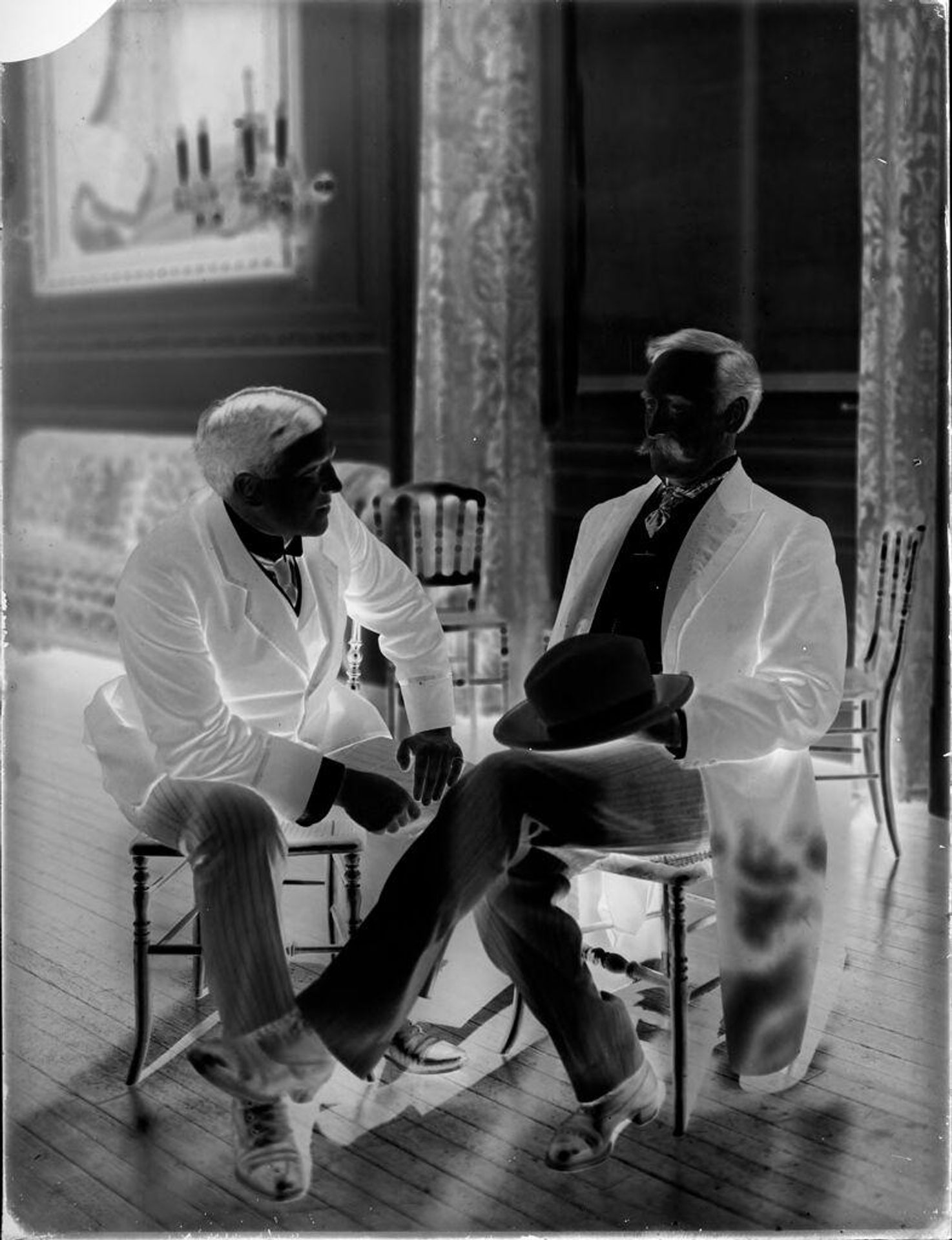 Untitled (two formally dresses men seated, sunlight, formal room) by Harris & Ewing