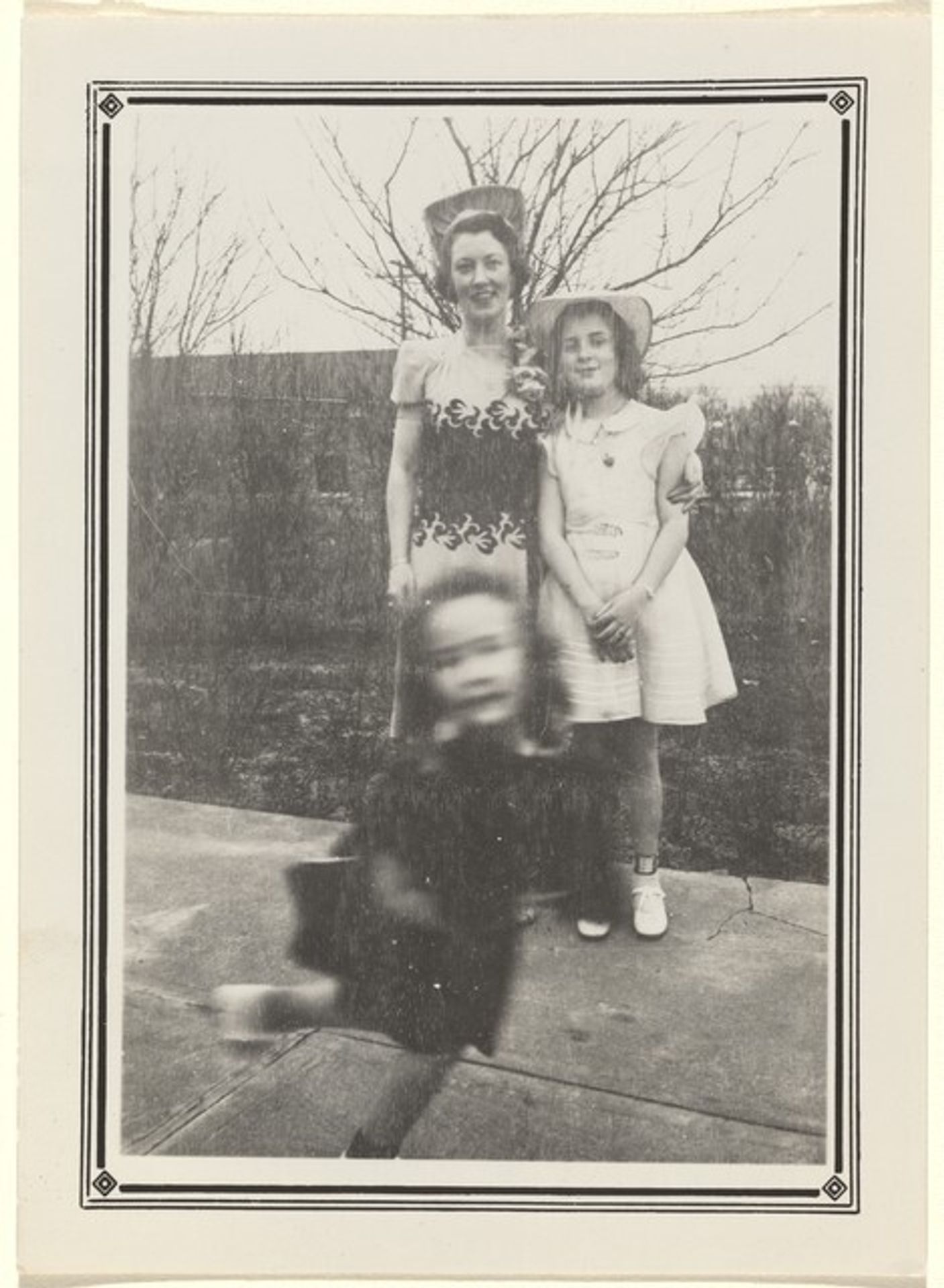 Untitled (Blurred girl in front of woman and girl posing) by Anonymous