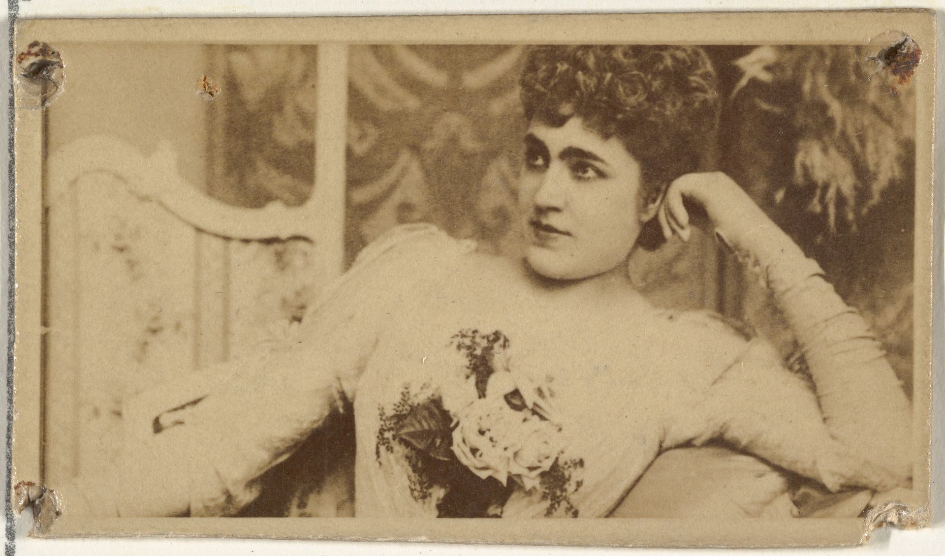 [Actress lounging while holding bouquet of flowers], from the Actors and Actresses series (N145-8) issued by Duke Sons & Co. to promote Duke Cigarettes by W. Duke, Sons & Co.