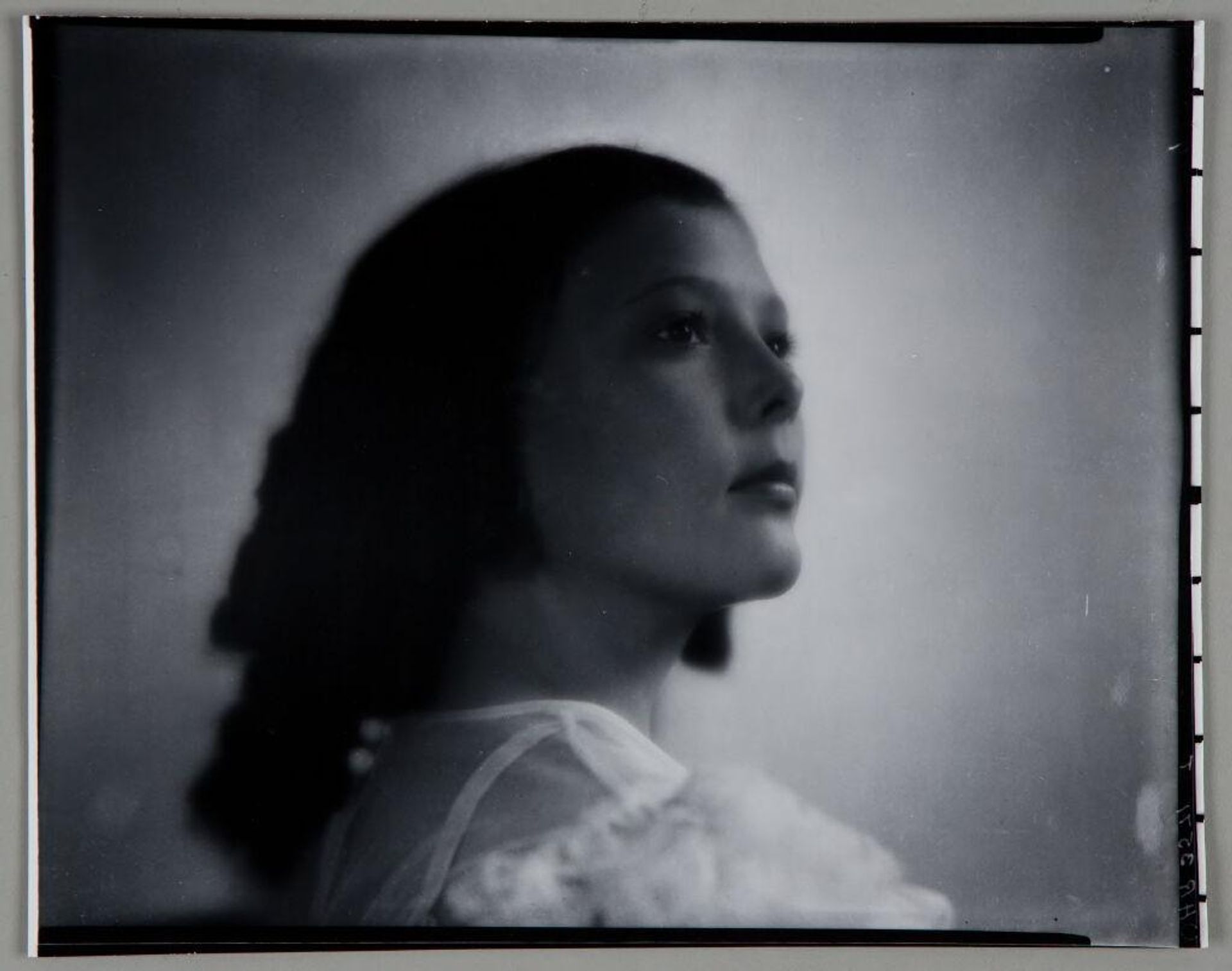 Untitled (portrait of girl seen from side, turning to look over shoulder) by Paul Gittings
