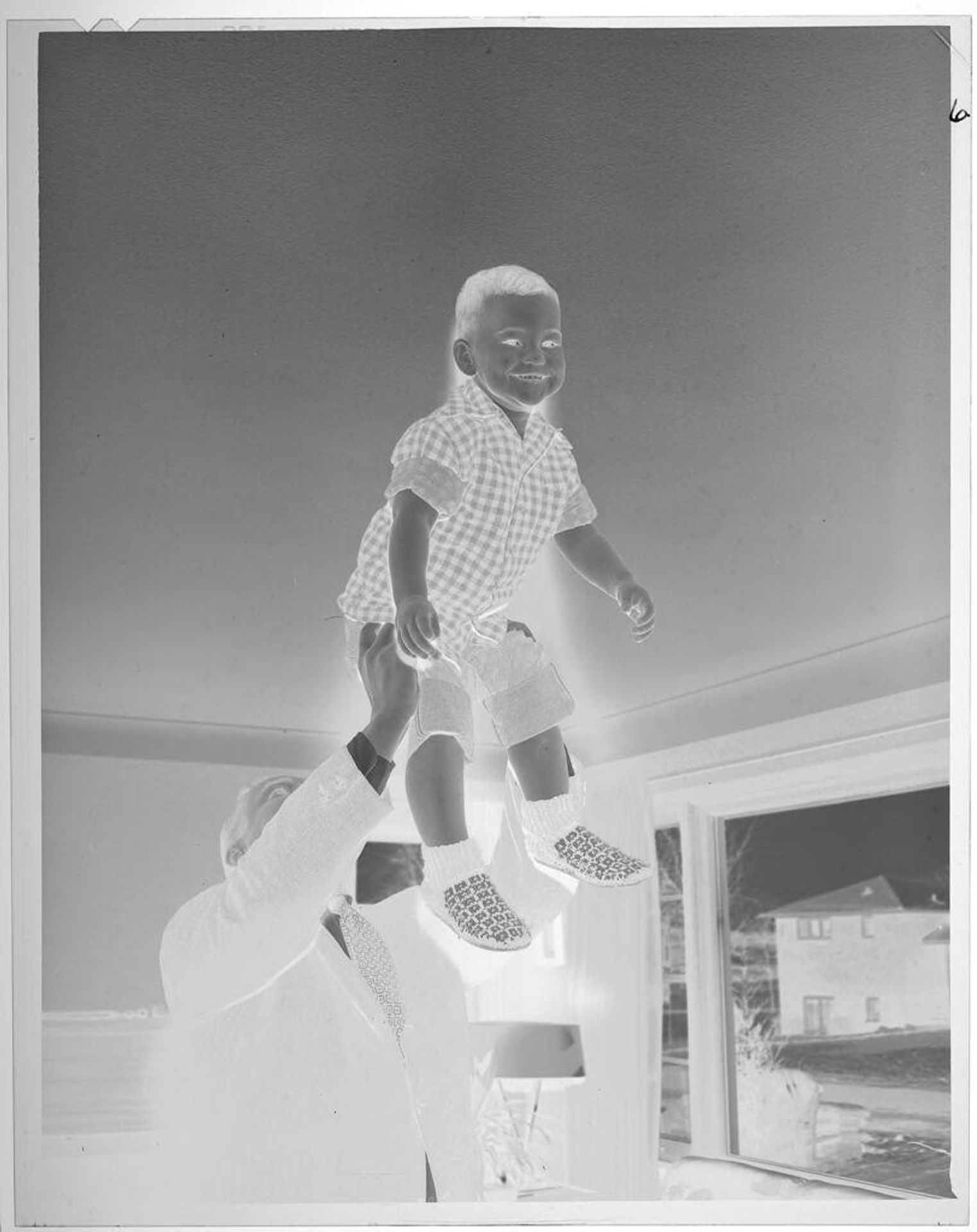 Untitled (man lifting smiling boy) by Lucian and Mary Brown
