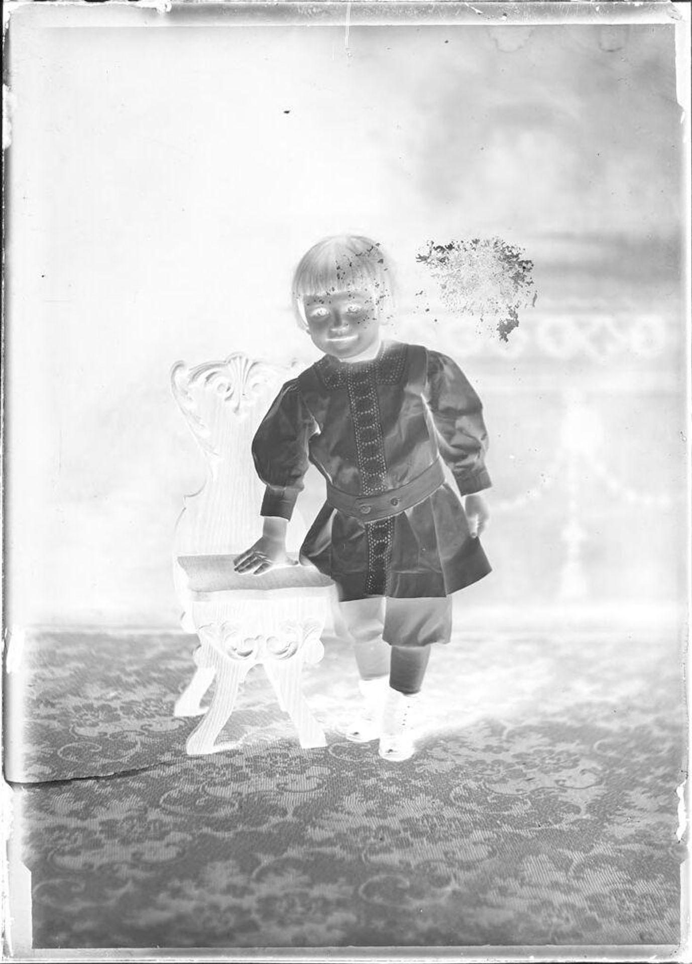 Untitled (portrait of child leaning on chair) by John Deusing