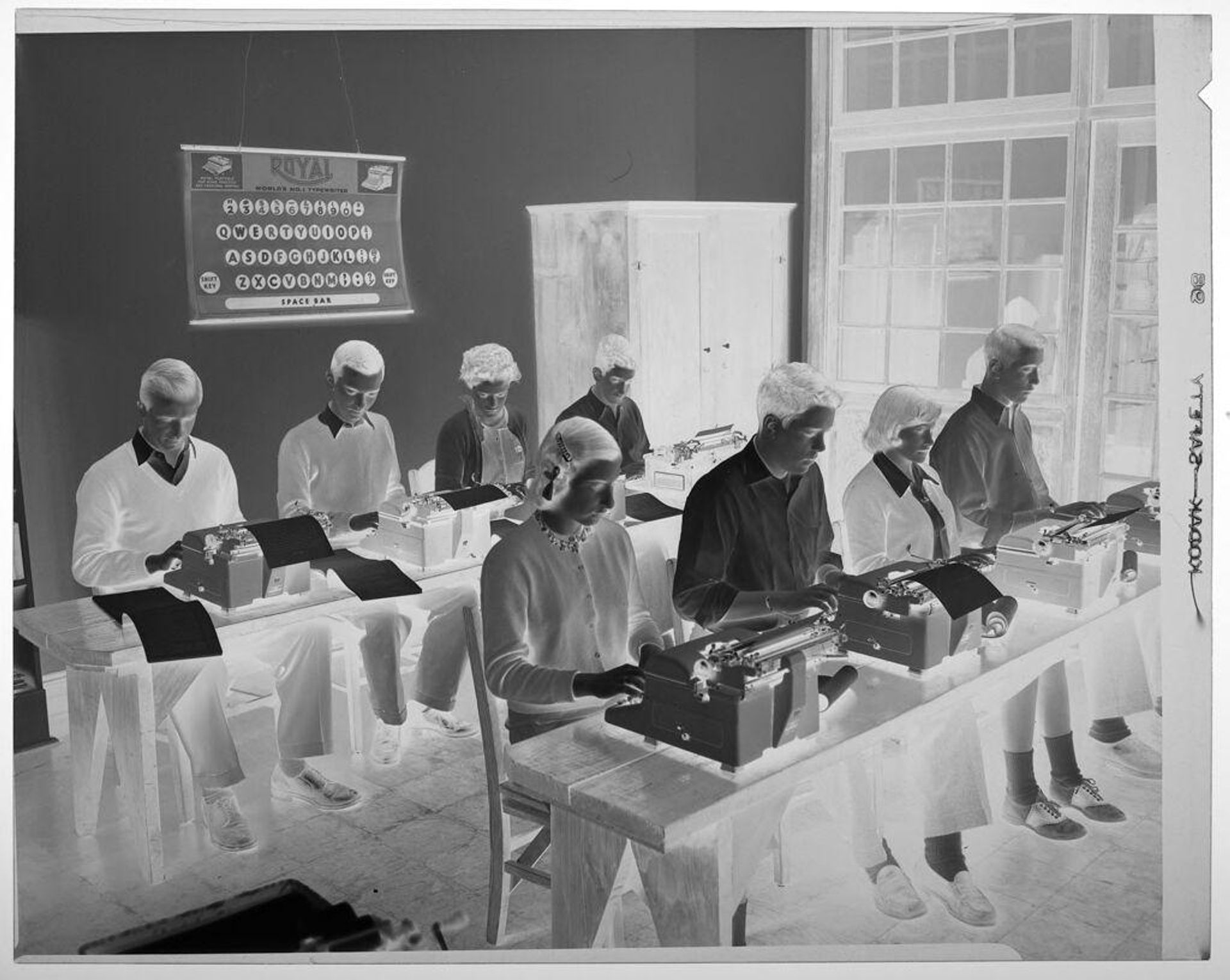 Untitled (eight students working on typewriters in classroom) by Martin Schweig