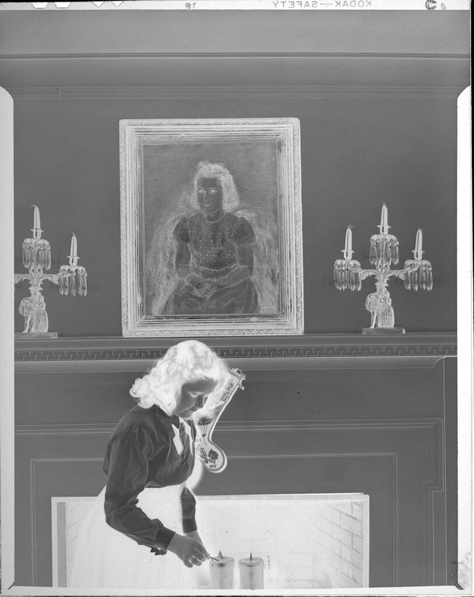 Untitled (girl lighting candles in front of painting) by John Howell