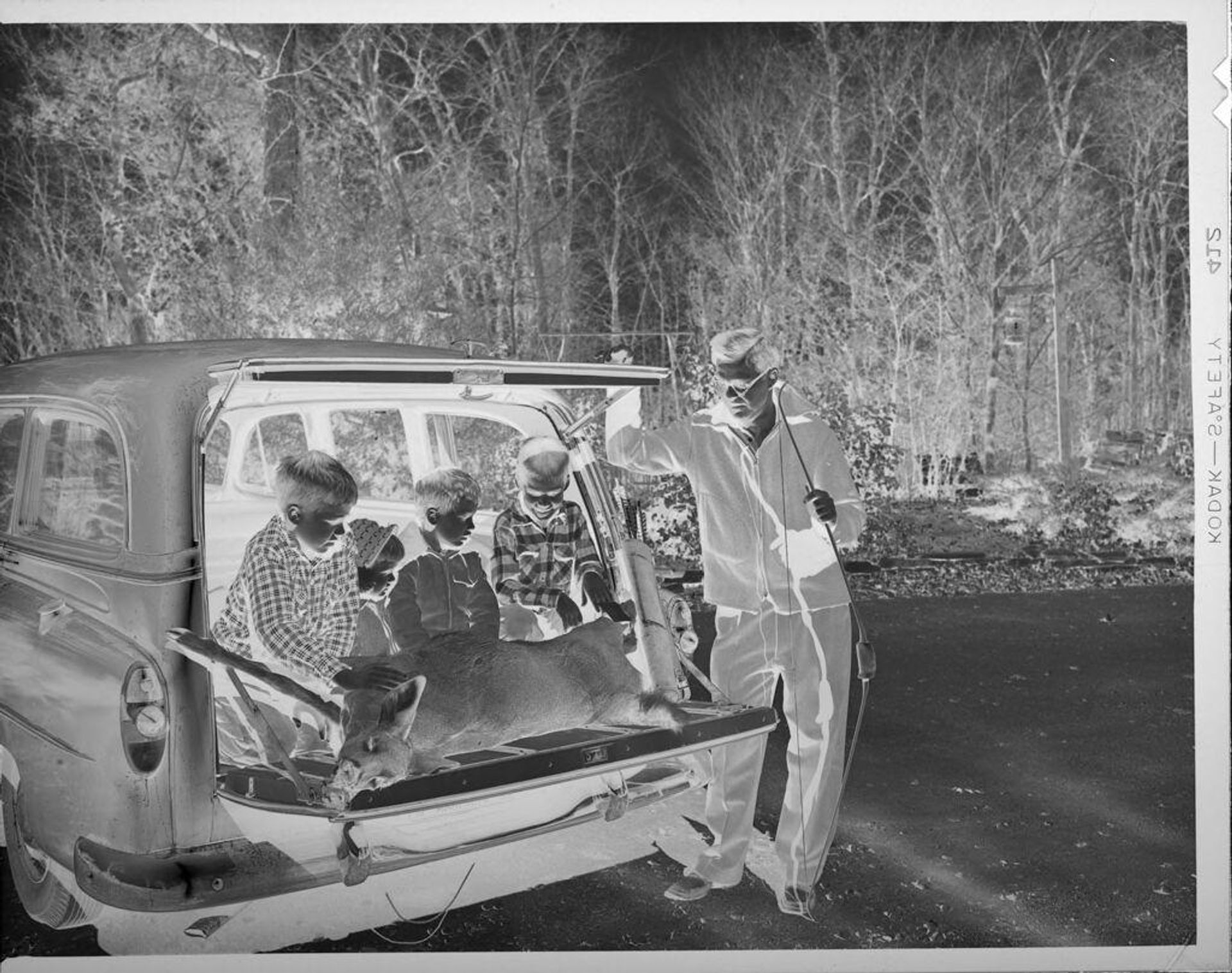 Untitled (boys in back of car with dead deer) by Lucian and Mary Brown