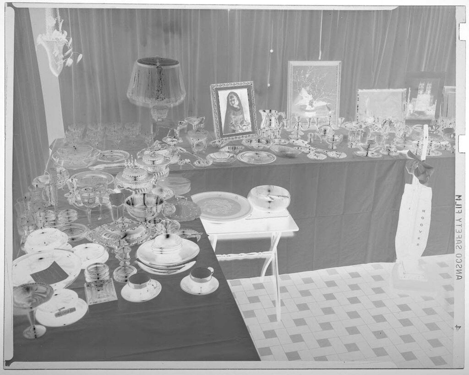 Untitled (two tables covered with wedding gifts including silver and china) by Martin Schweig