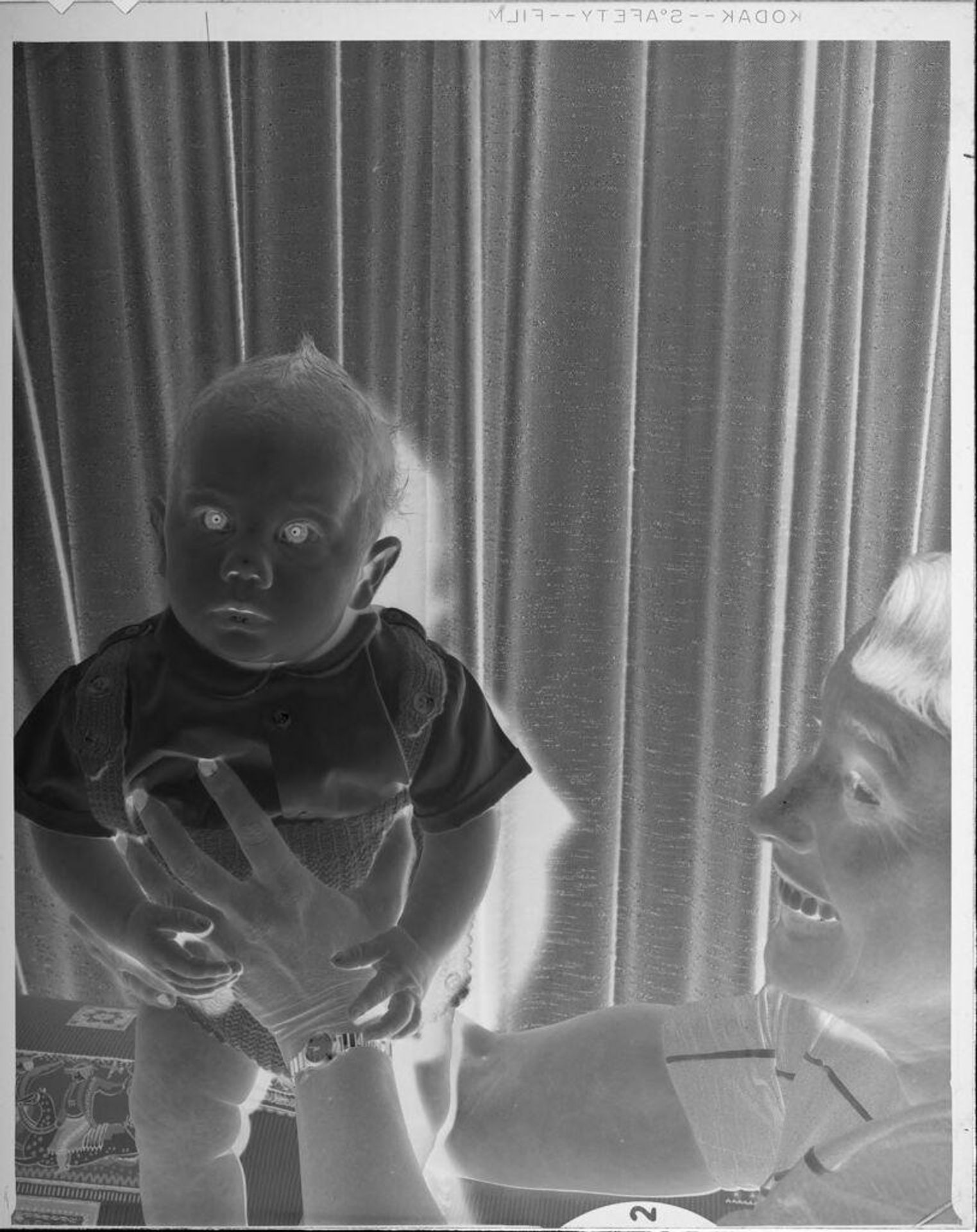 Untitled (woman holding baby up) by Lucian and Mary Brown