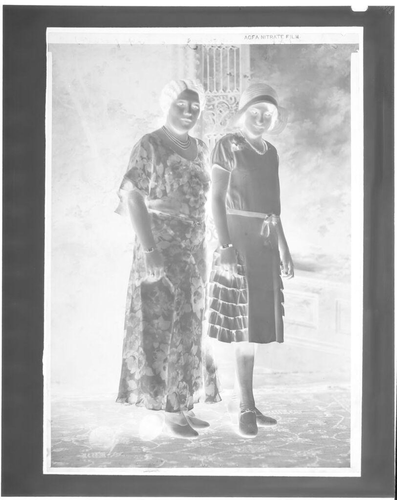 Untitled (two women standing for portrait in studio) by John Deusing