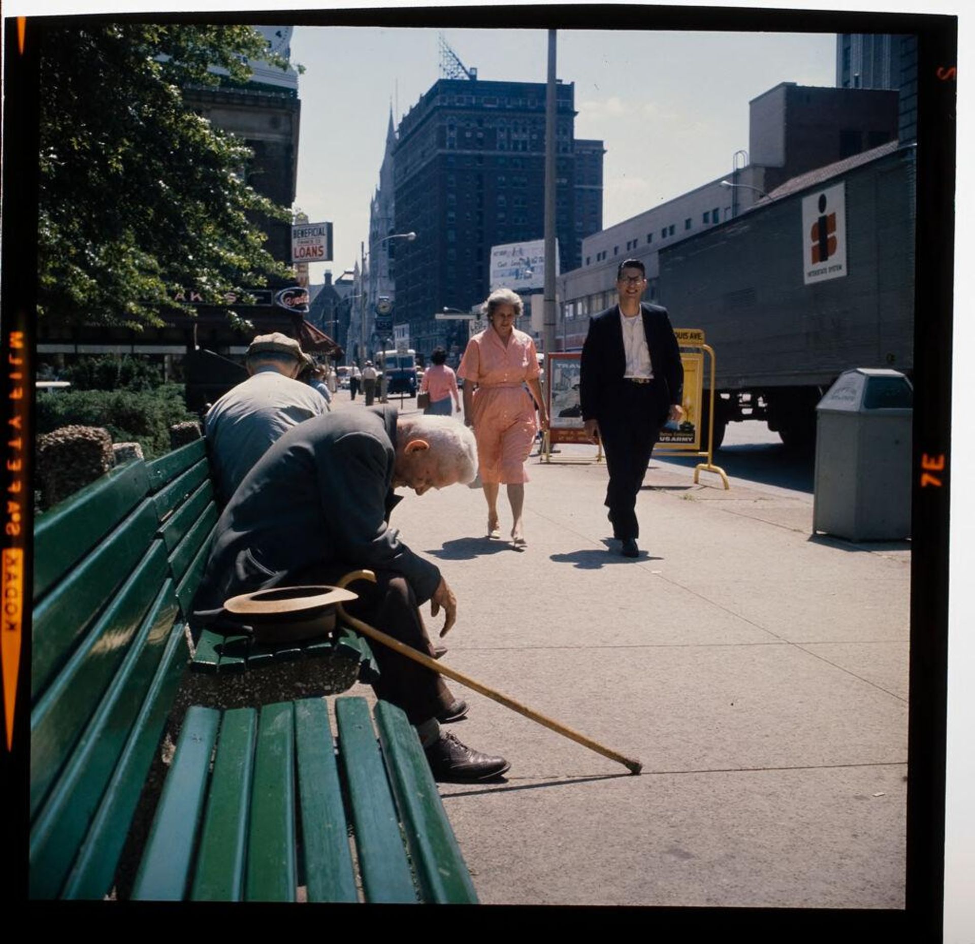Untitled (elderly man sitting on city bench, head down) by Jack Gould