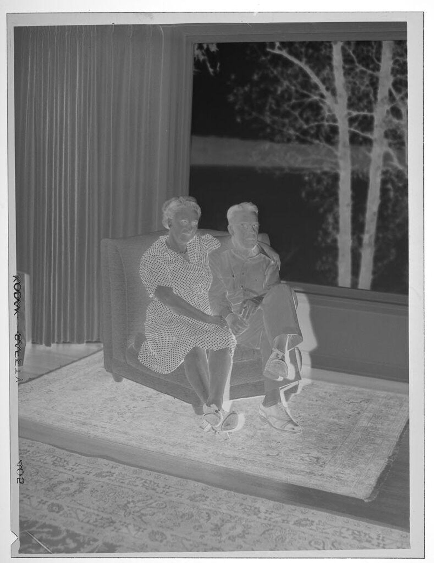 Untitled (man and woman in chair by window) by Lucian and Mary Brown