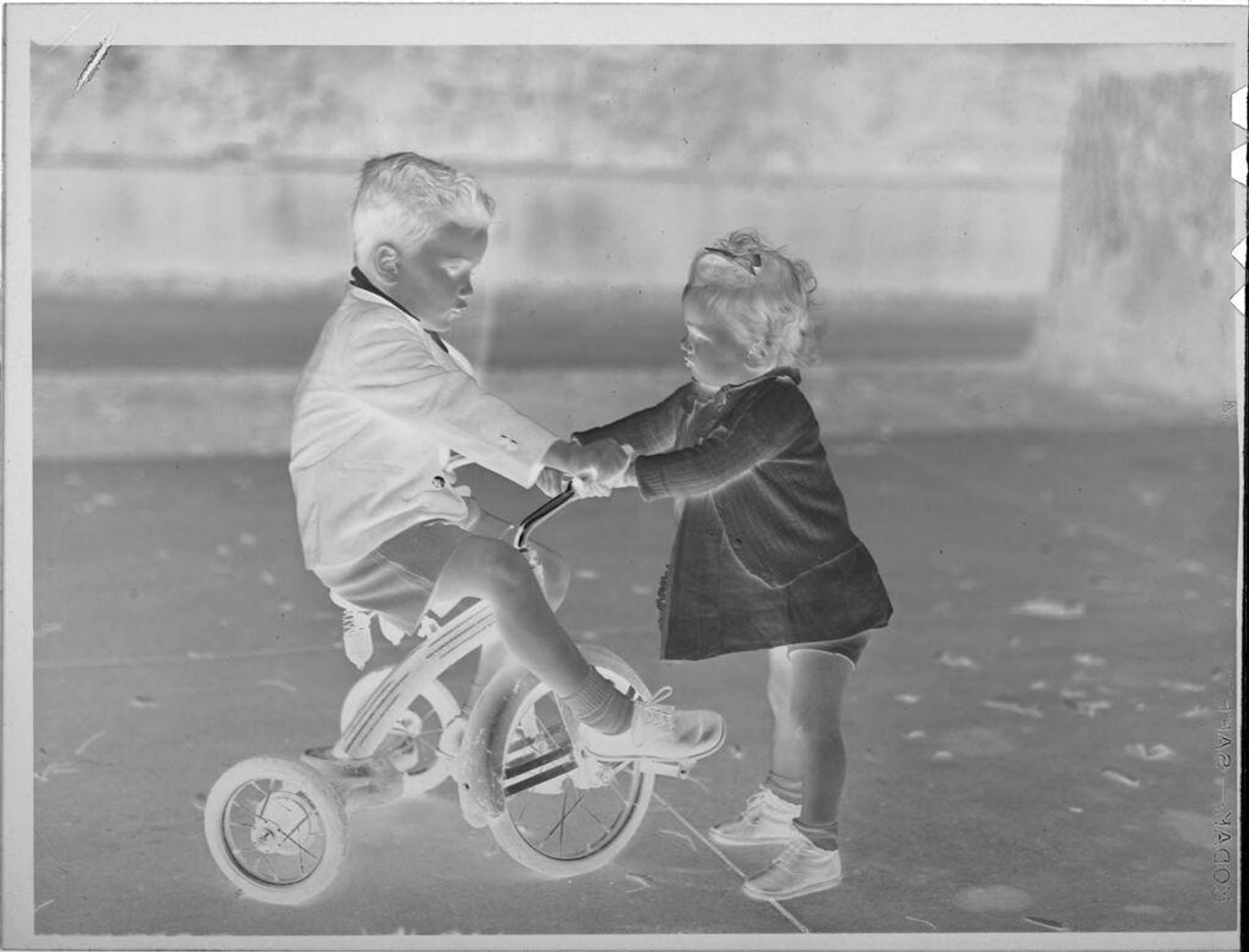 Untitled (boy with tricycle and little girl) by Lucian and Mary Brown