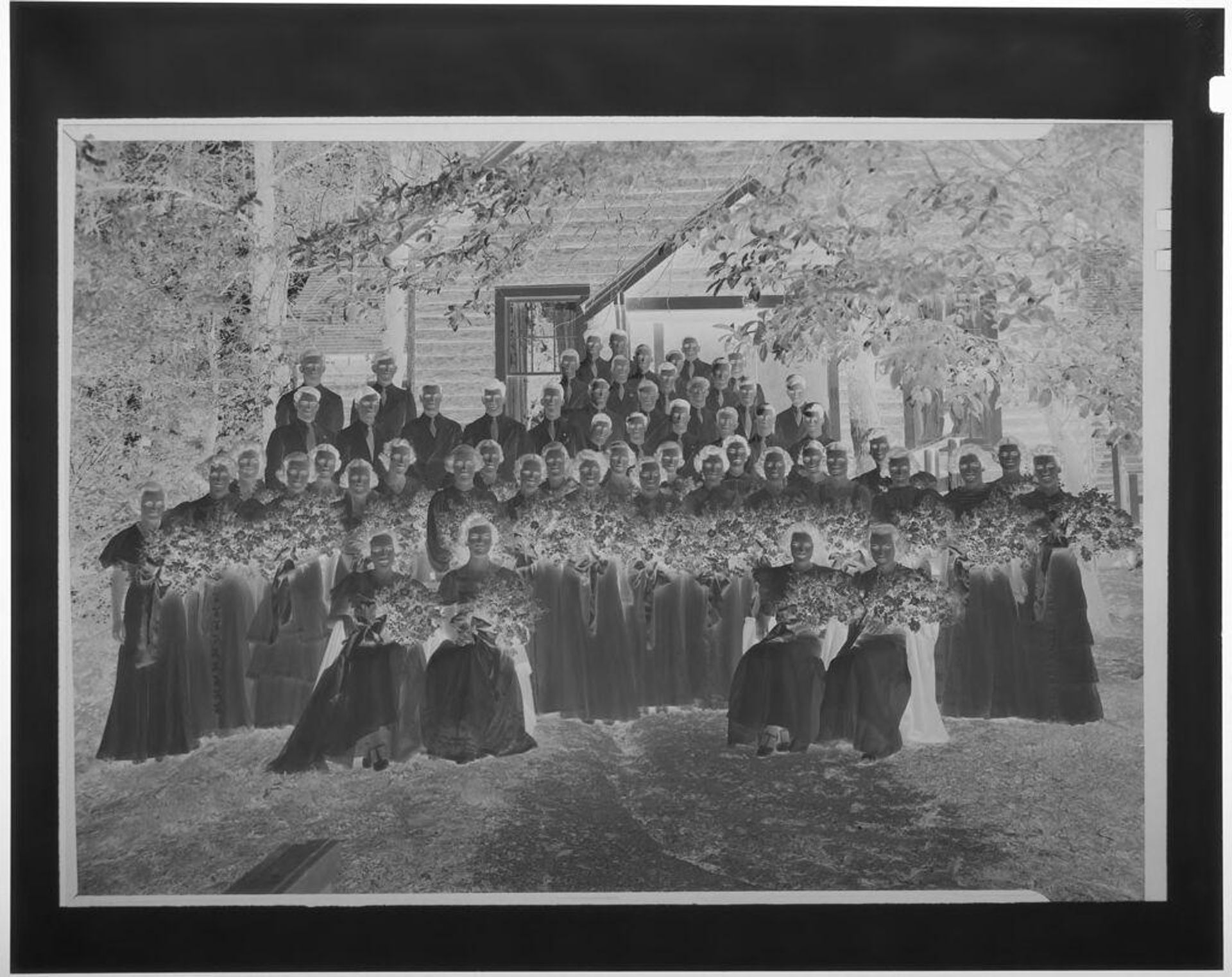 Untitled (group portrait of teenage students wearing formal wear outside building with women hoding bouquets) by Martin Schweig
