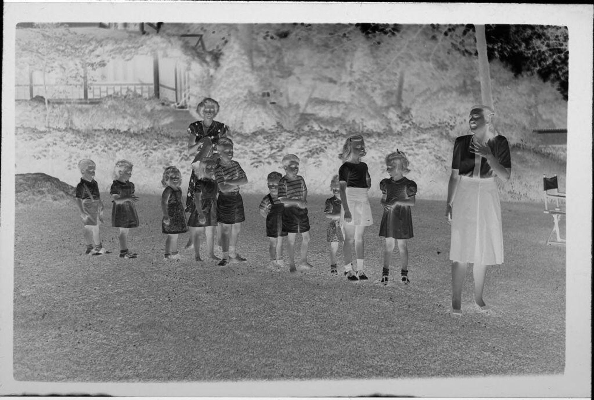 Untitled (children lined up on grass outside house) by Lucian and Mary Brown