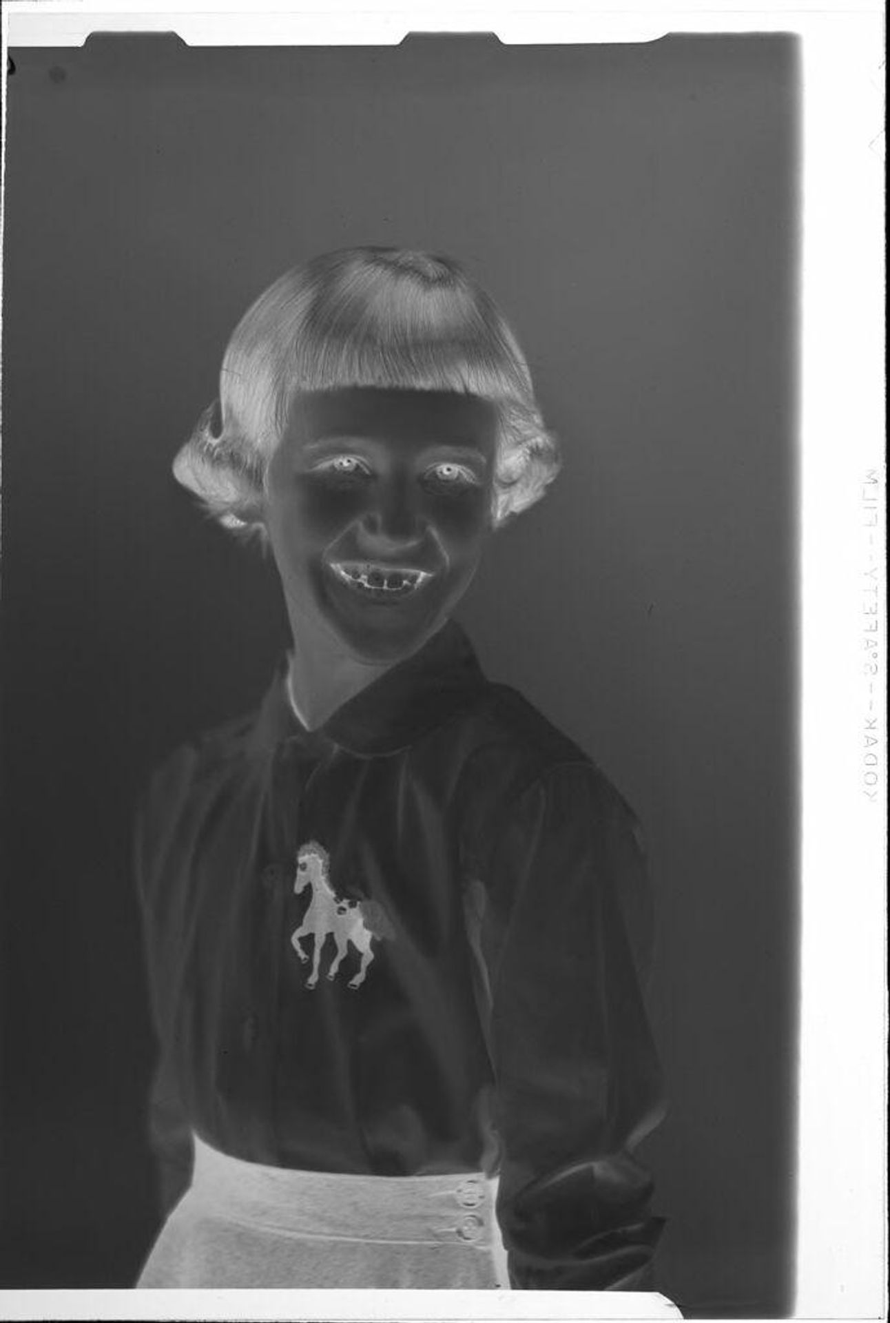 Untitled (portrait of girl with horse on shirt) by Ken Whitmire Associates