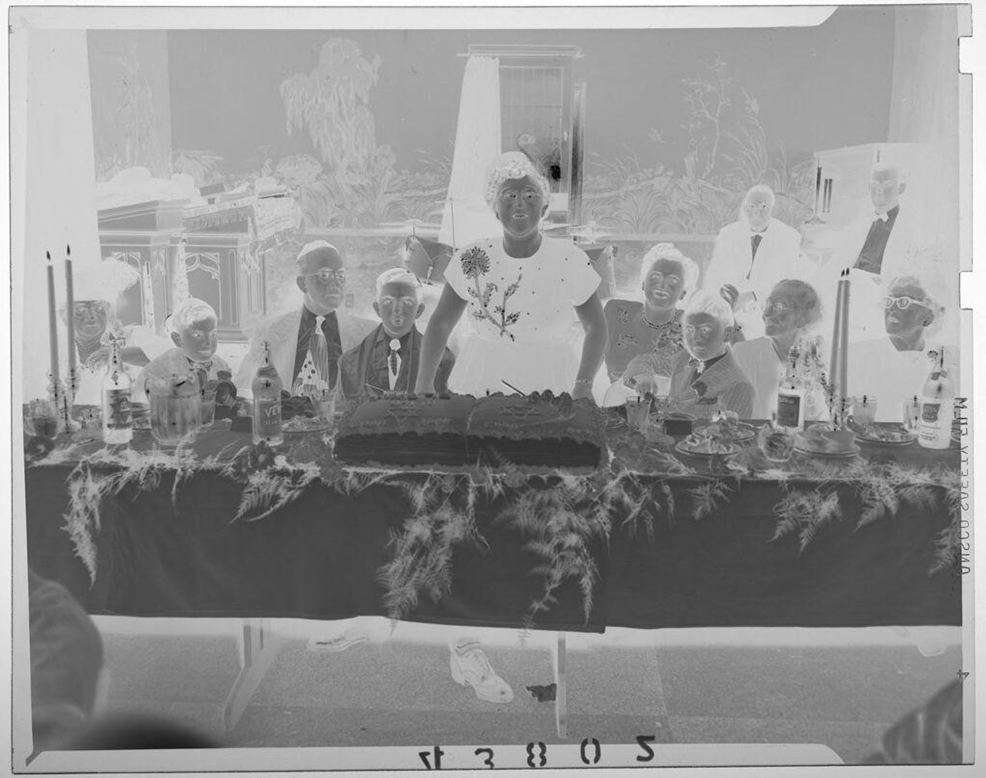 Untitled (woman standing in front of cake at banquet table filled with people at Jewish party) by Martin Schweig