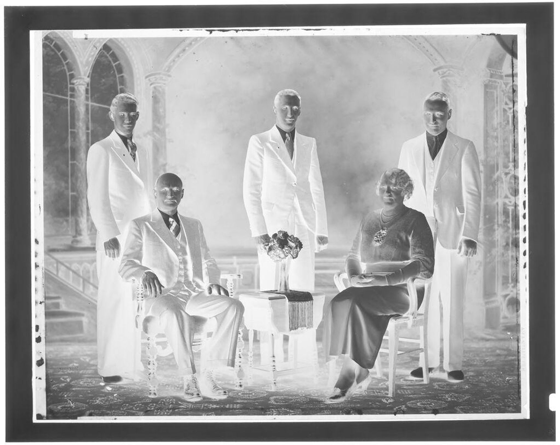 Untitled (four men and one woman in studio for formal portrait) by John Deusing