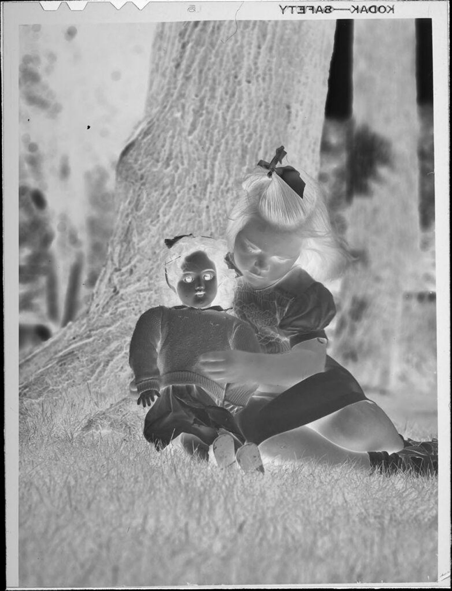 Untitled (girl and doll next to tree) by Lucian and Mary Brown