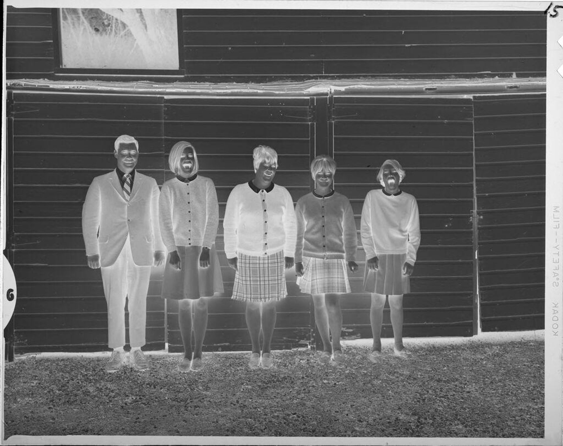 Untitled (portrait of family lined up against house) by Lucian and Mary Brown