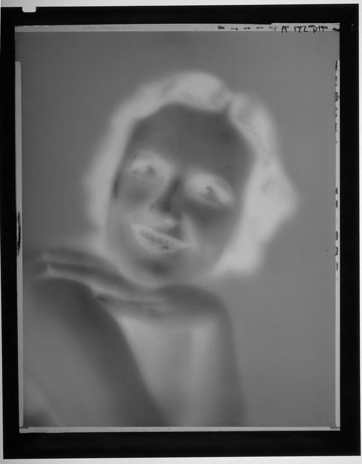 Untitled (portrait of young woman with chin on hand on bare shoulder) by Paul Gittings