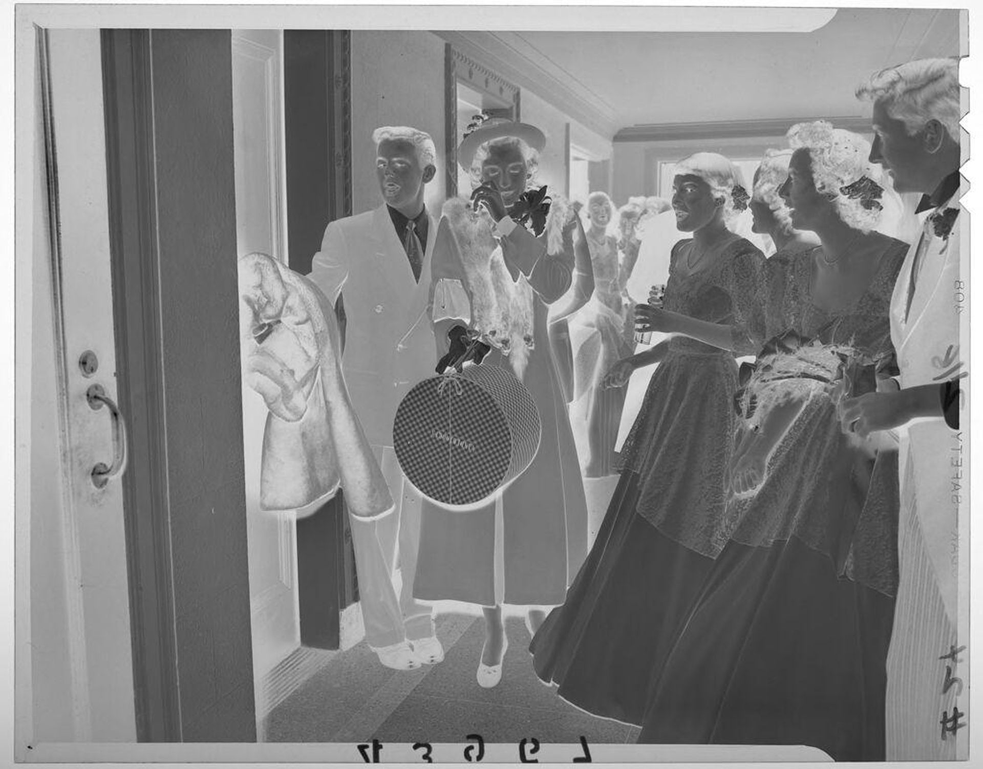 Untitled (newlywed couple in coats departing as bridesmaids and guests watch) by Martin Schweig