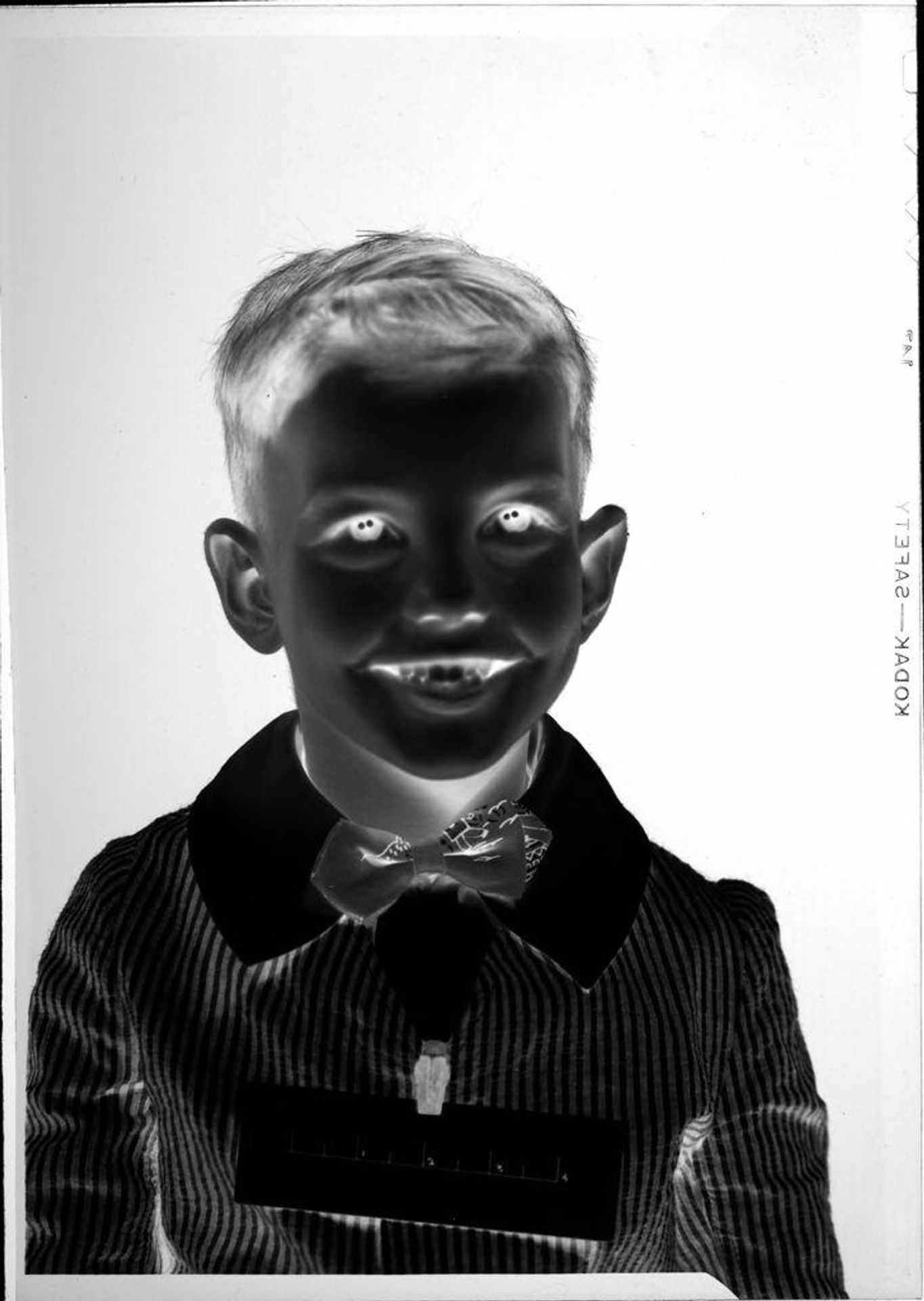 Untitled (portrait of boy with measuring tape on coat) by Robert Burian