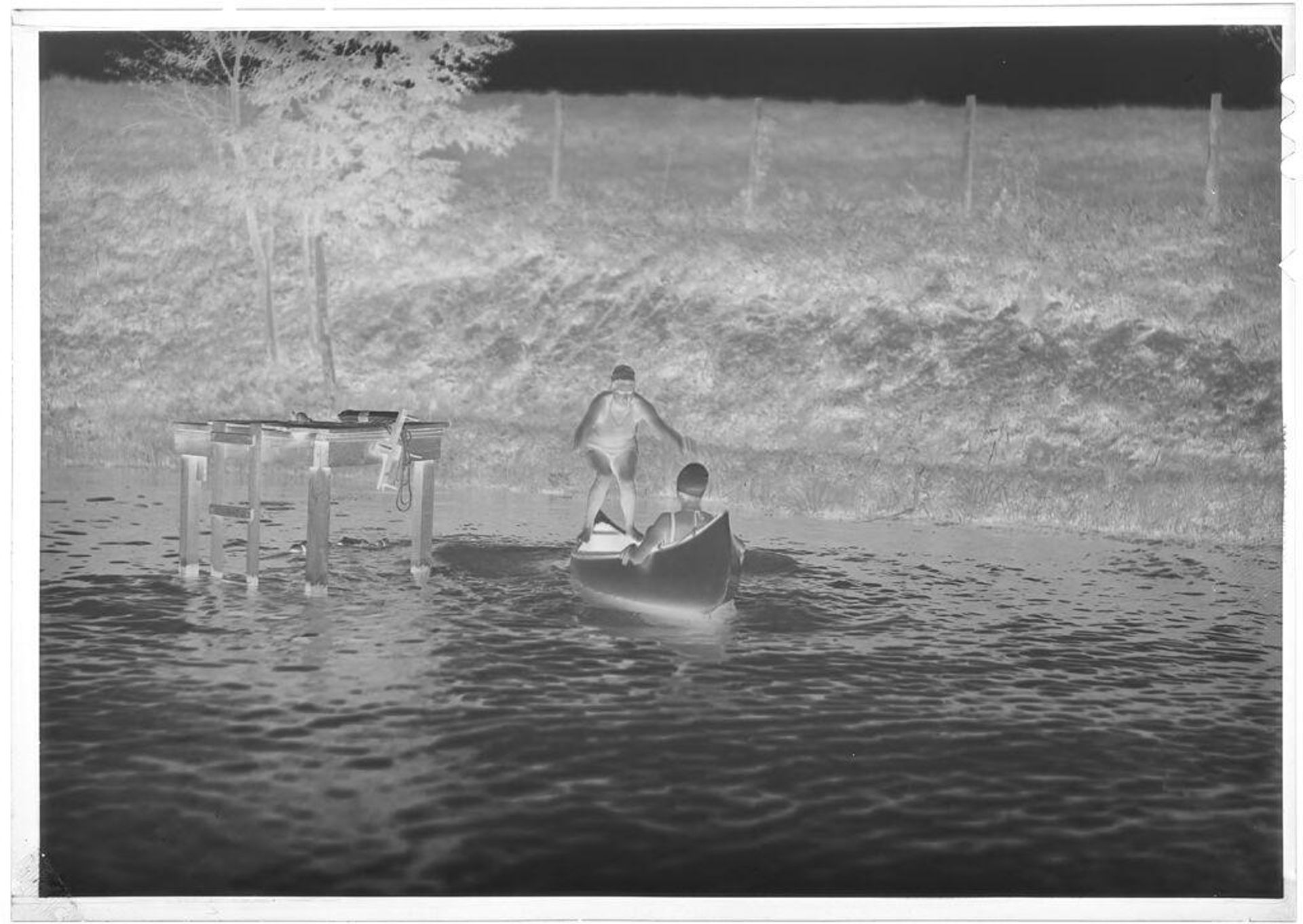 Untitled (two Girl Scouts in canoe, one balancing on gunwales) by Hamblin Studio