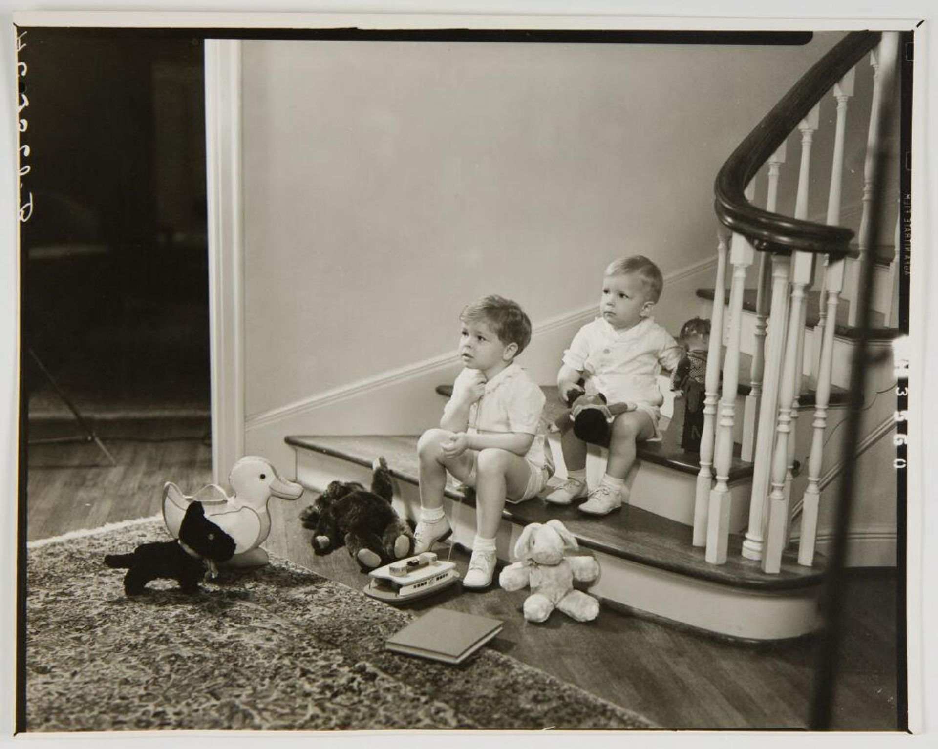 Untitled (two children on stairs with toys) by Paul Gittings