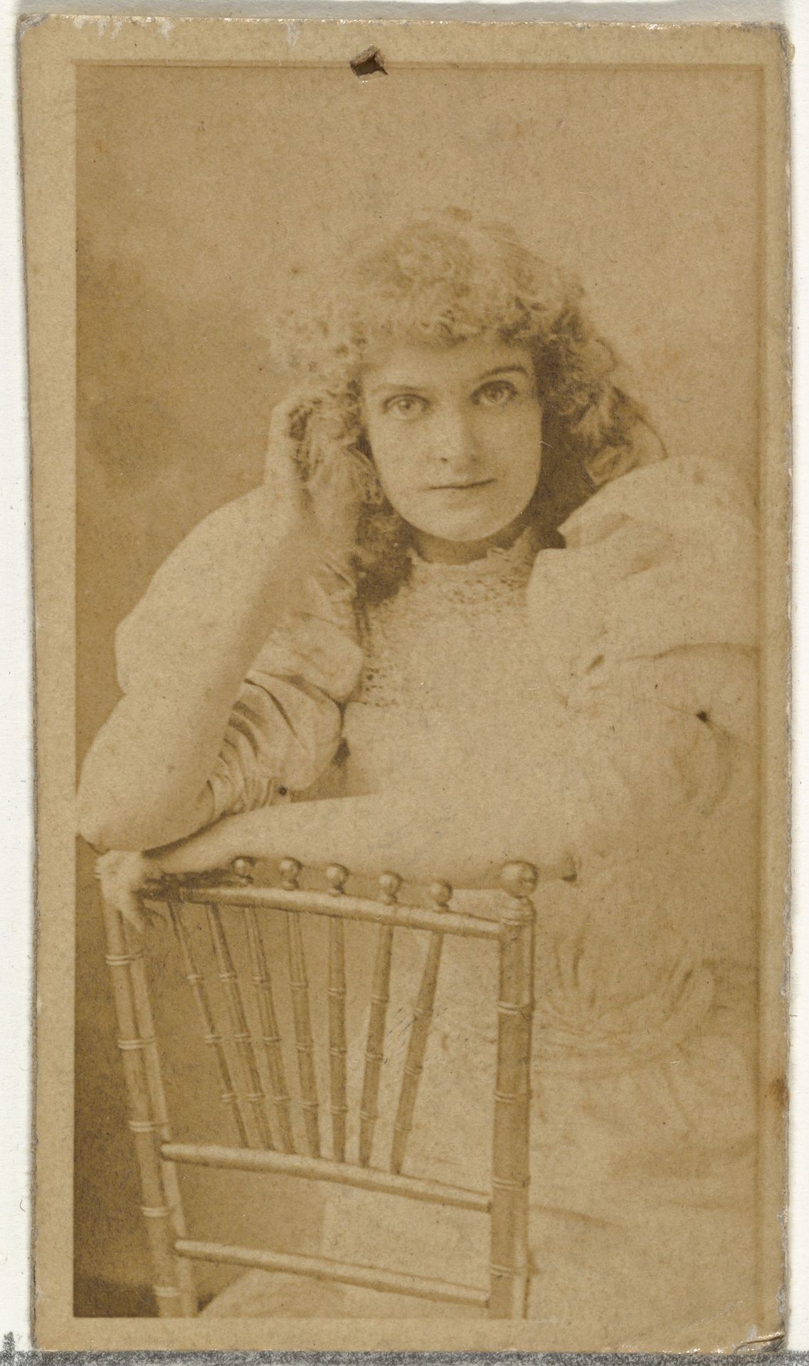 [Actress posing on chair], from the Actors and Actresses series (N145-8) issued by Duke Sons & Co. to promote Duke Cigarettes by W. Duke, Sons & Co.