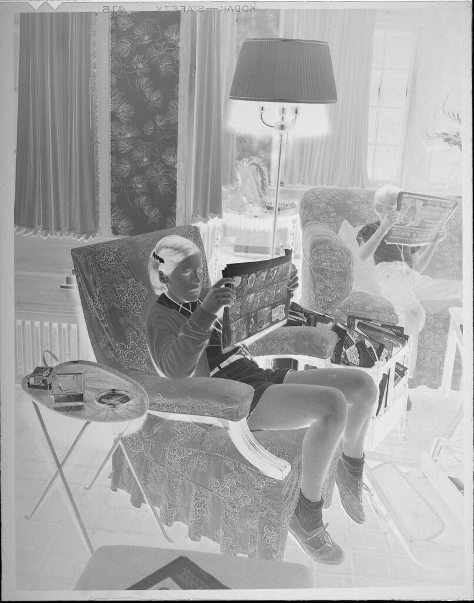 Untitled (girl reading comics) by Lucian and Mary Brown