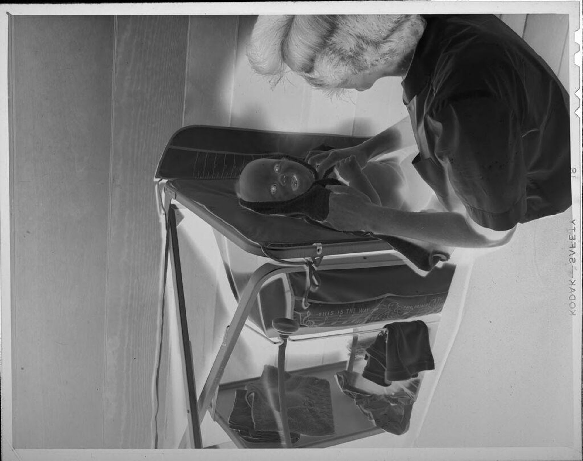 Untitled (woman with baby on changing table) by Lucian and Mary Brown