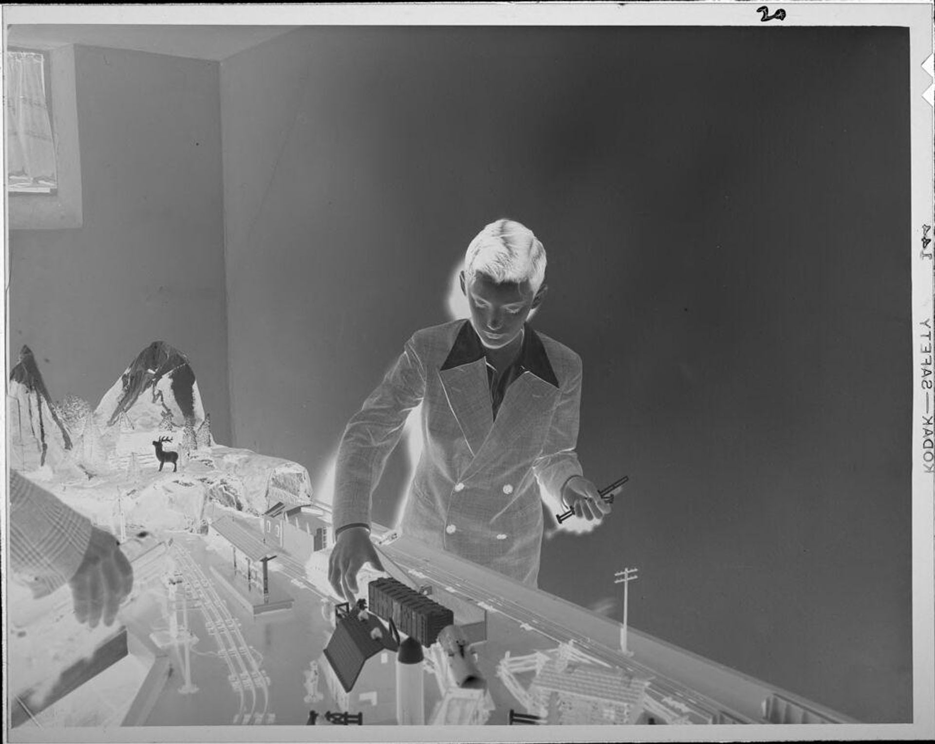 Untitled (boy playing with model train) by Lucian and Mary Brown