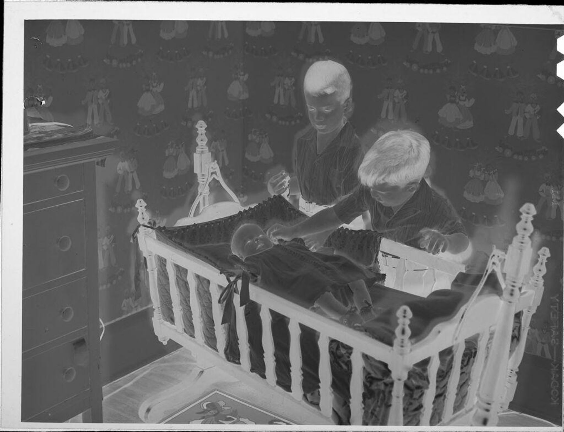 Untitled (two boys with baby in crib) by Lucian and Mary Brown