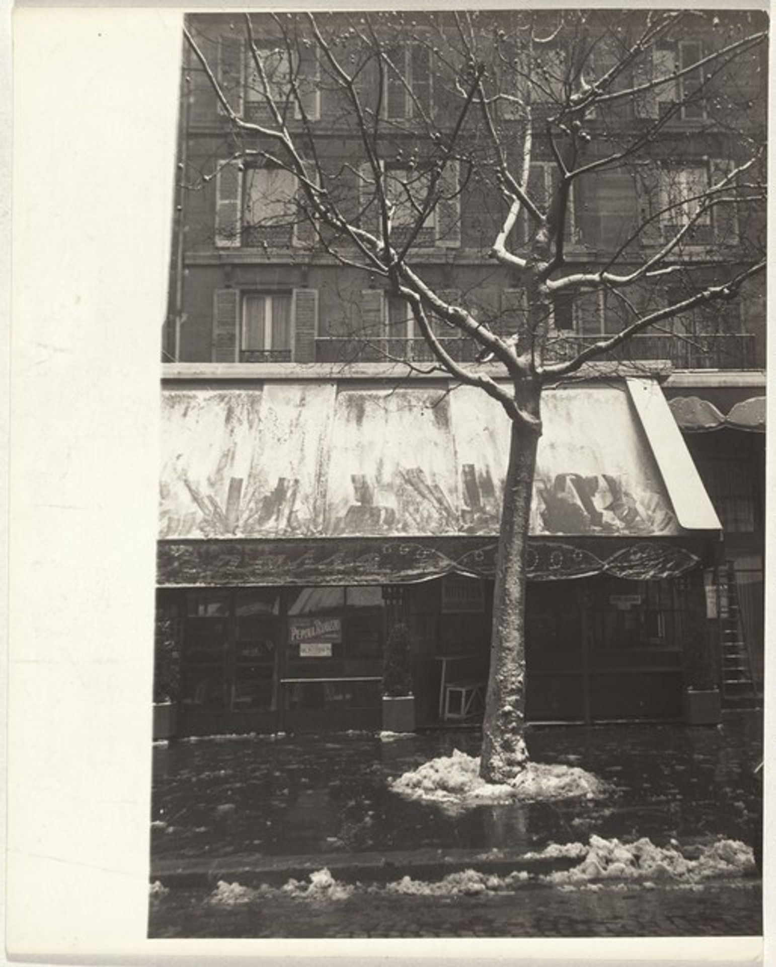 Café front in snow, Paris by Robert Frank