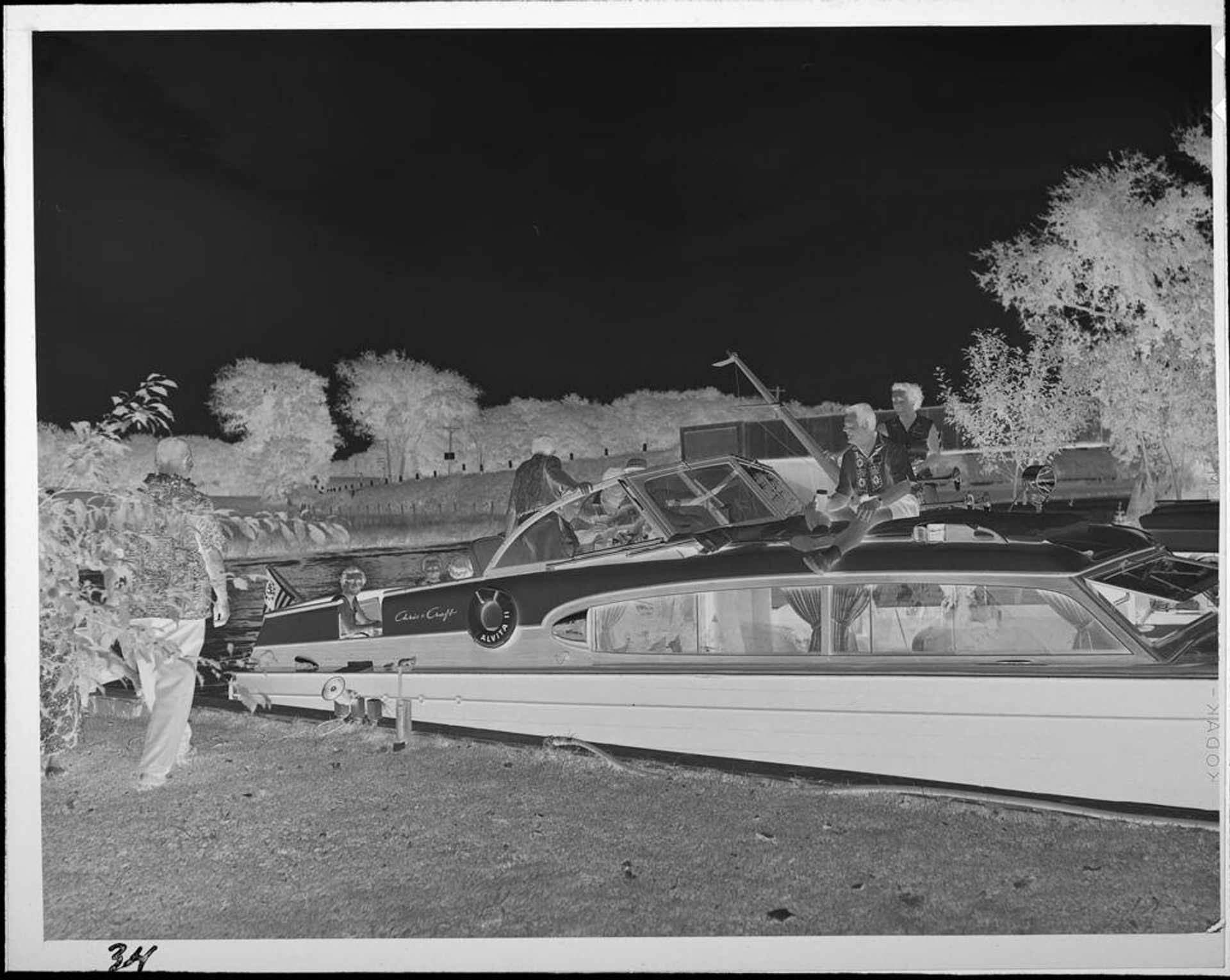 Untitled (people on boat next to shore) by Lucian and Mary Brown