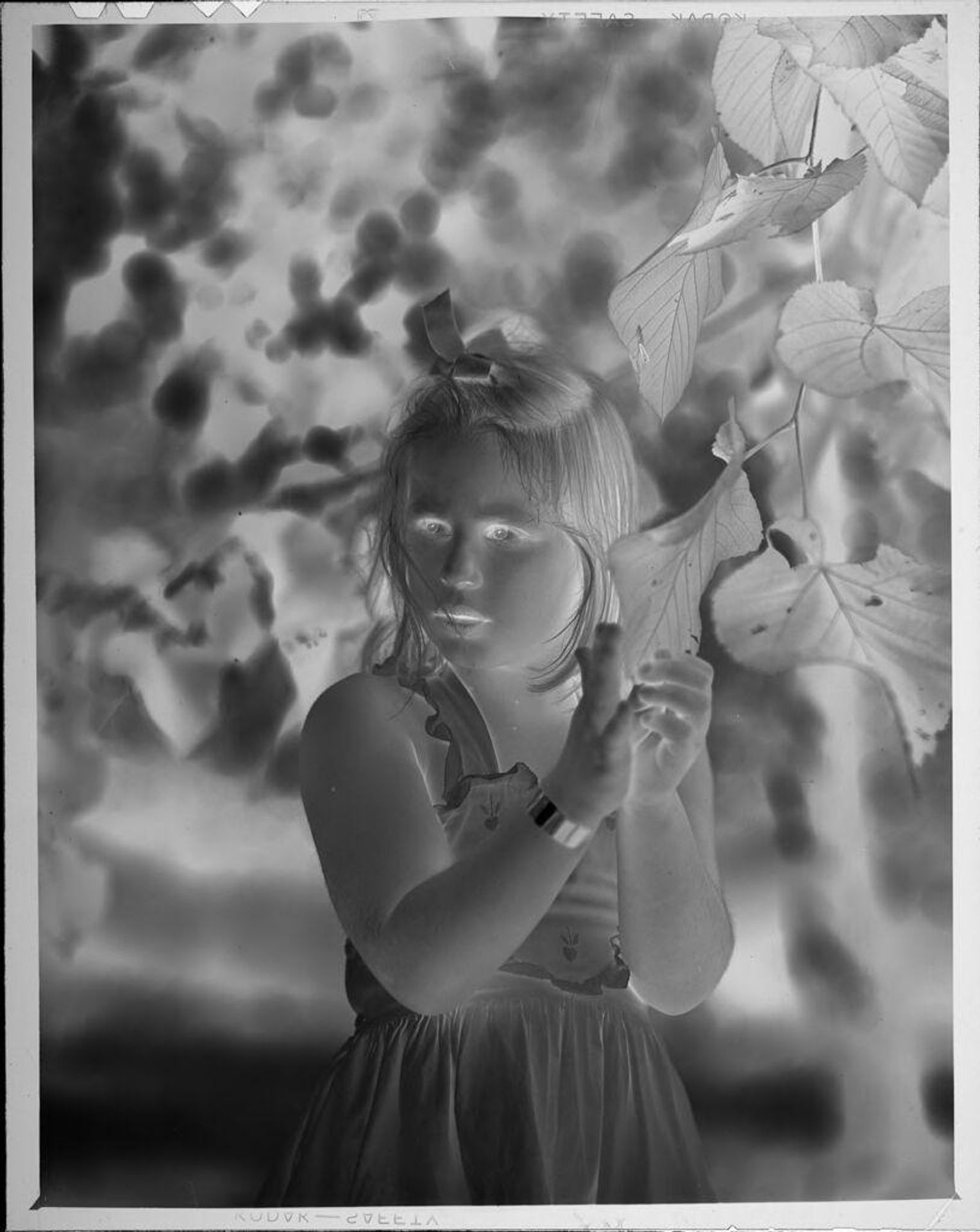 Untitled (portrait of girl next to tree) by Lucian and Mary Brown