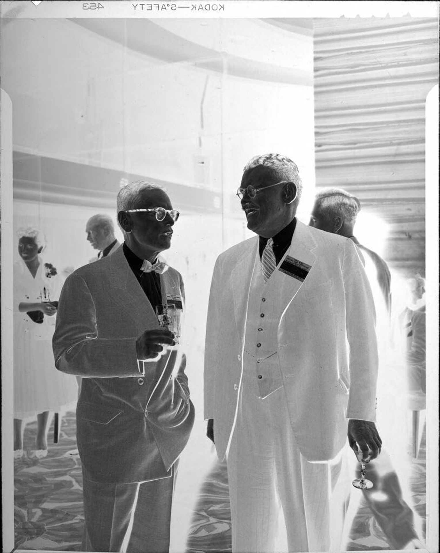 Untitled (two men at party) by Peter James Studio