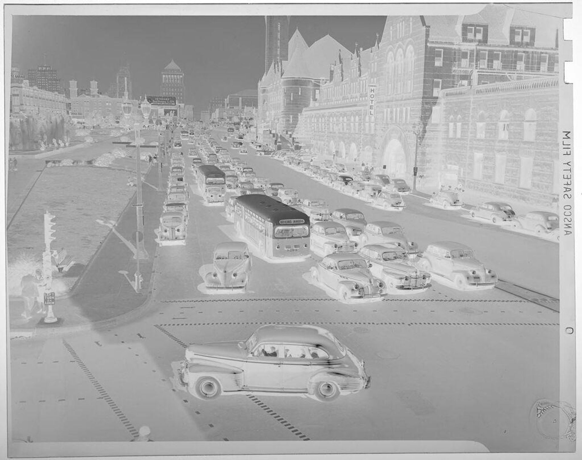 Untitled (city view with large street, cars, and large stone buildings) by Jack Gould