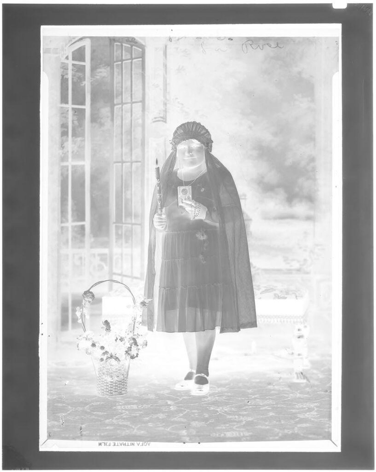 Untitled (girl posing in studio with bible, candle and rosary) by John Deusing