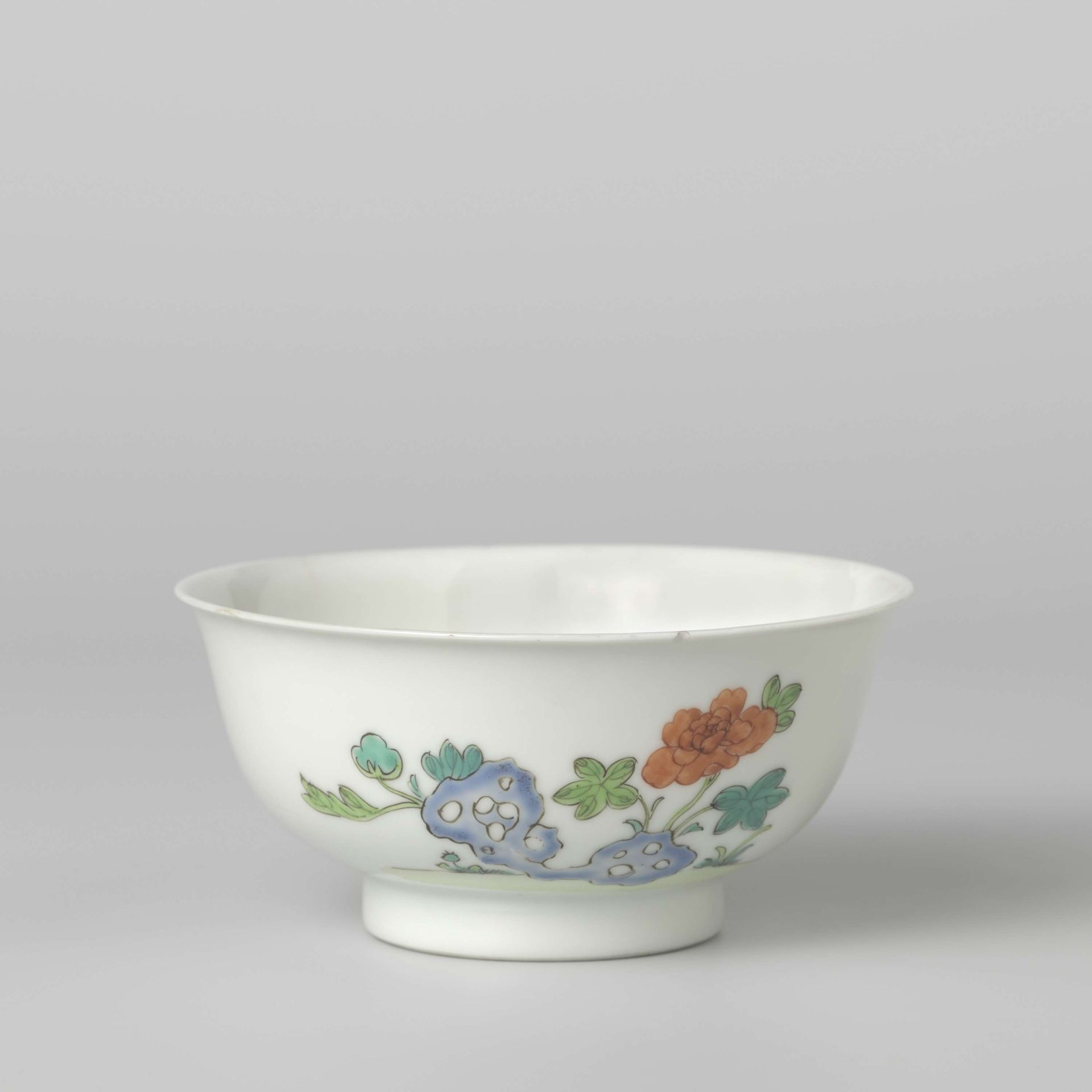 Bell-shaped bowl with flower sprays and a flowering plant near a rock by Anonymous