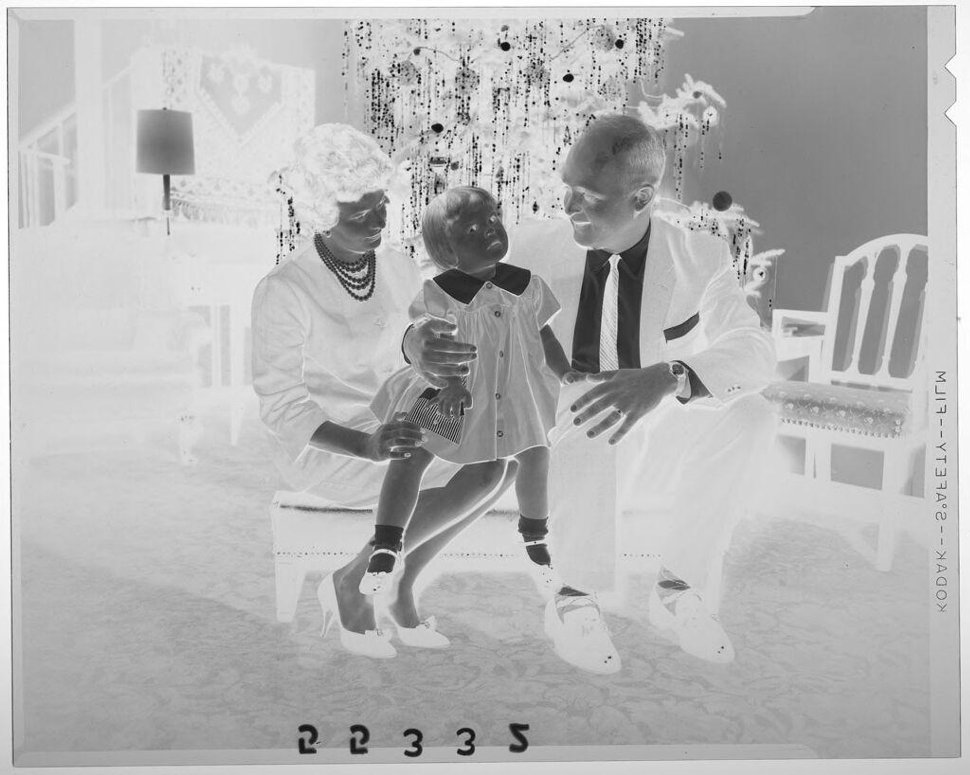 Untitled (couple posed sitting in front of Christmas tree looking at daughter) by Martin Schweig