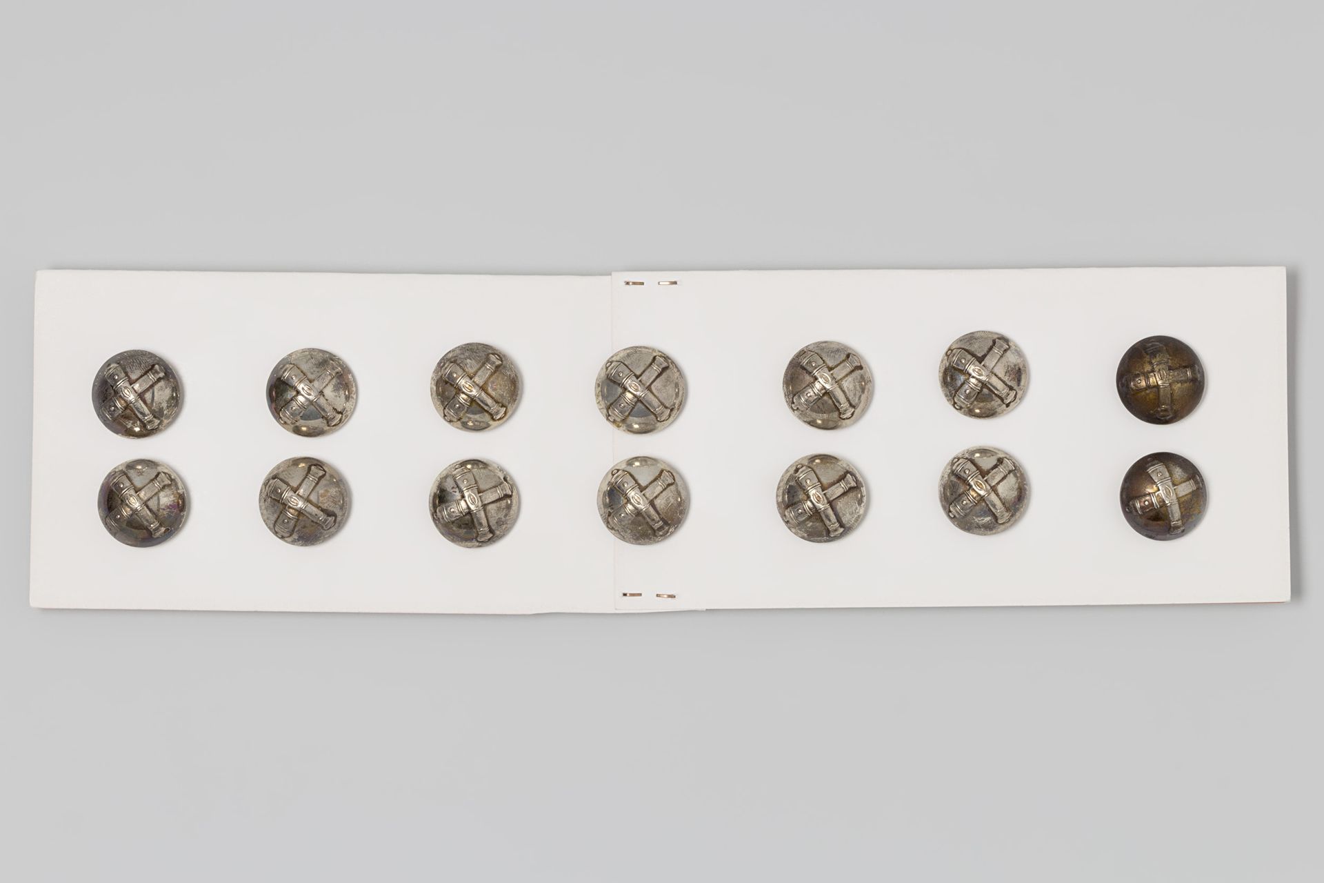 Bolvormige knoop van verzilverd koper, waarop twee gekruiste kanonnen in reliëf; onderdeel van een artillerie-uniform by P. Mansvelt & Zn