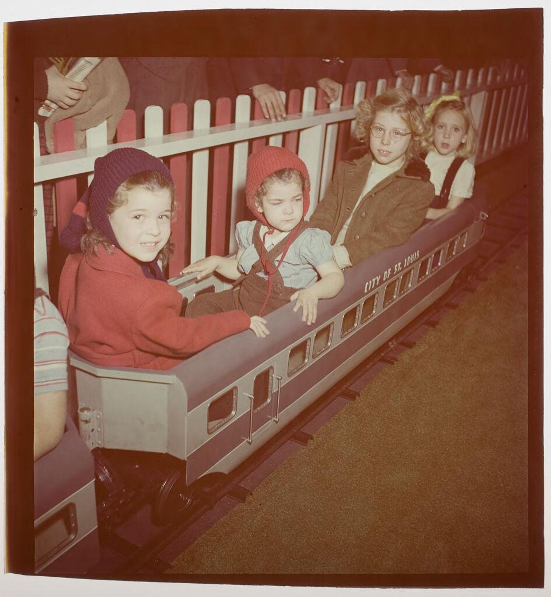 Untitled (children riding on toy train) by Jack Gould