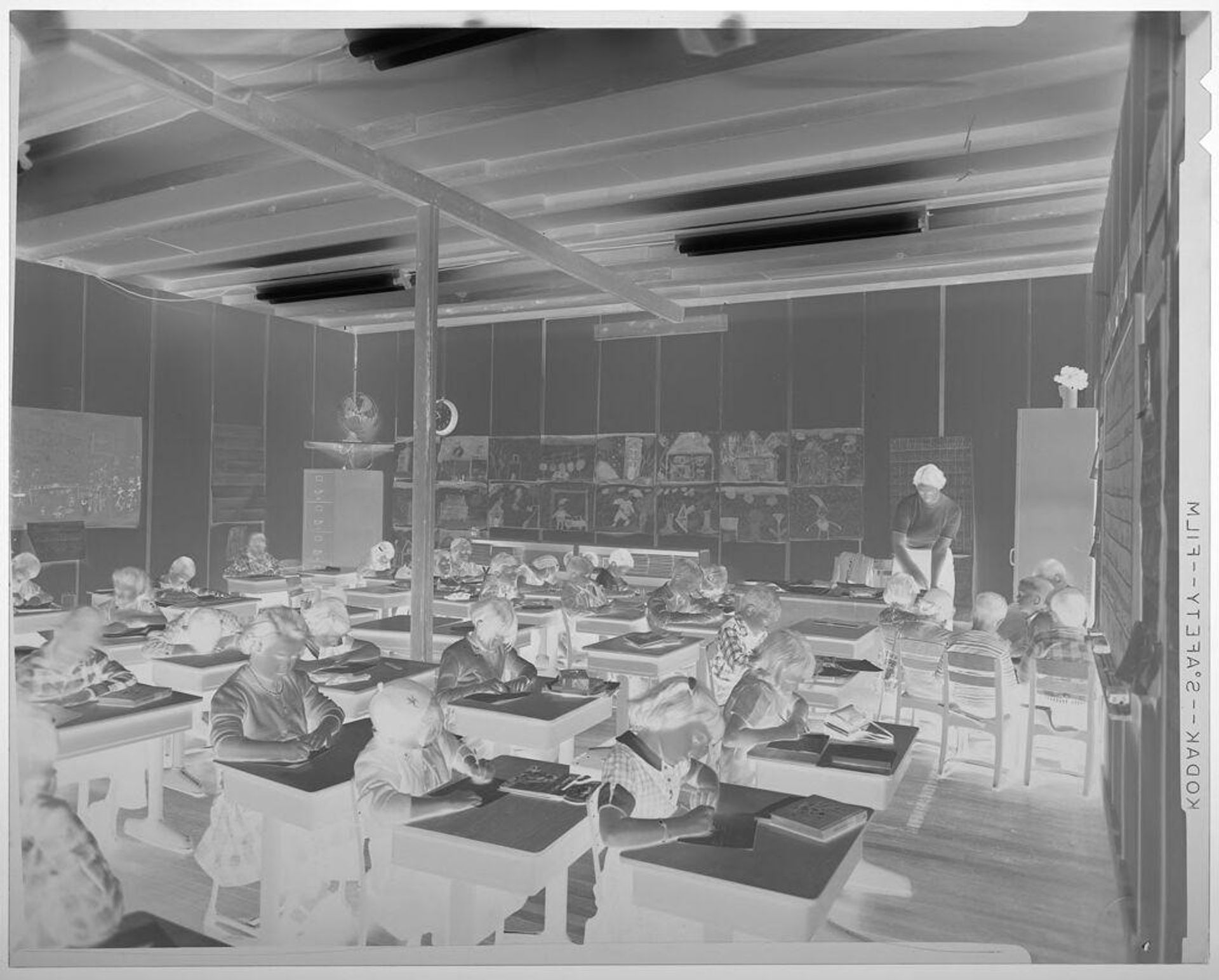 Untitled (elementary school classroom with children and teacher, children at individual desks) by Jack Gould