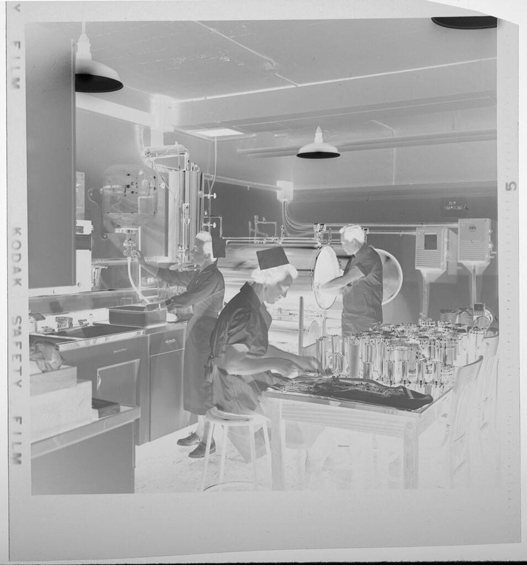 Untitled (women gathered around hospital bed) by Jack Gould