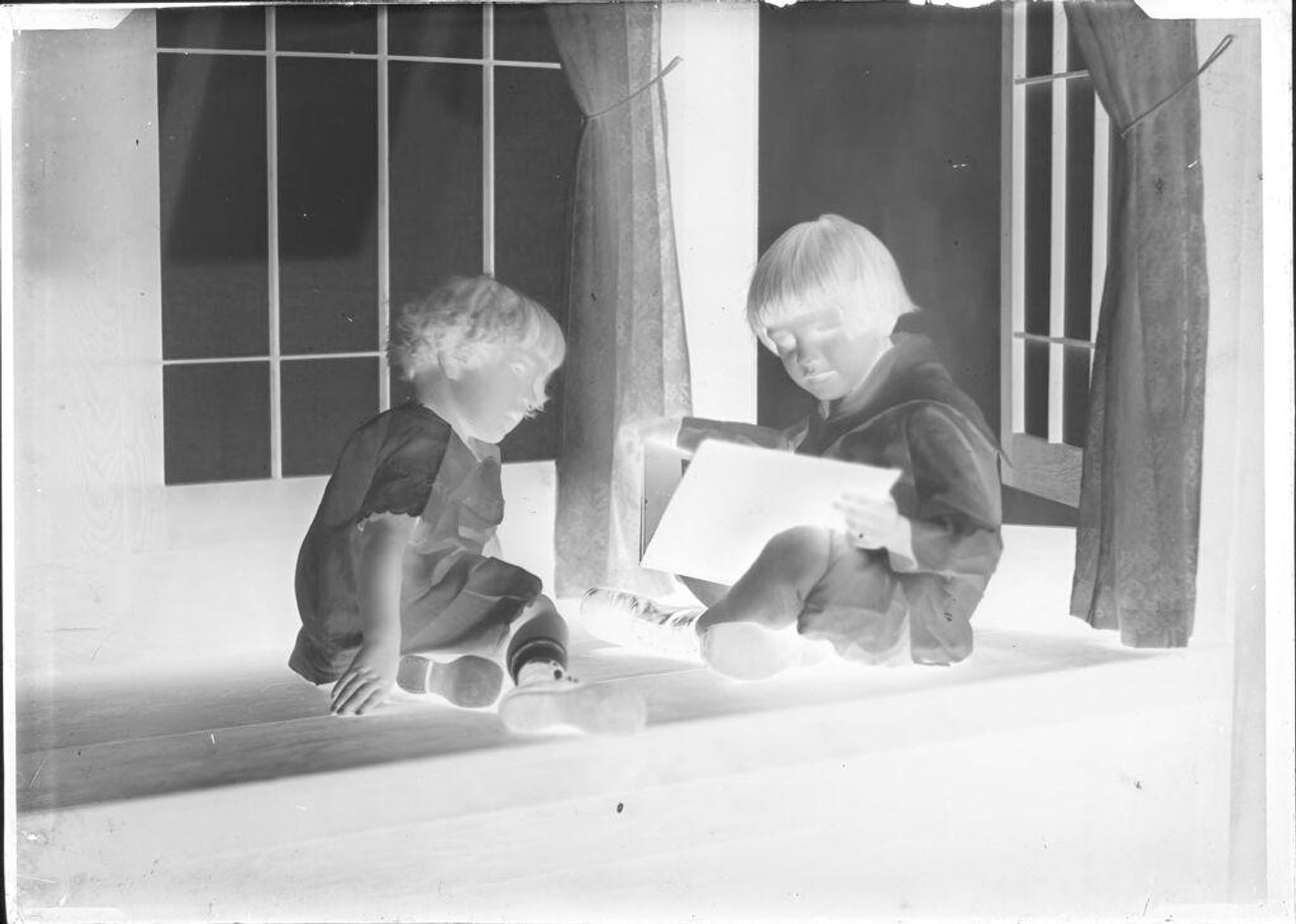 Untitled (two children with book) by John Deusing