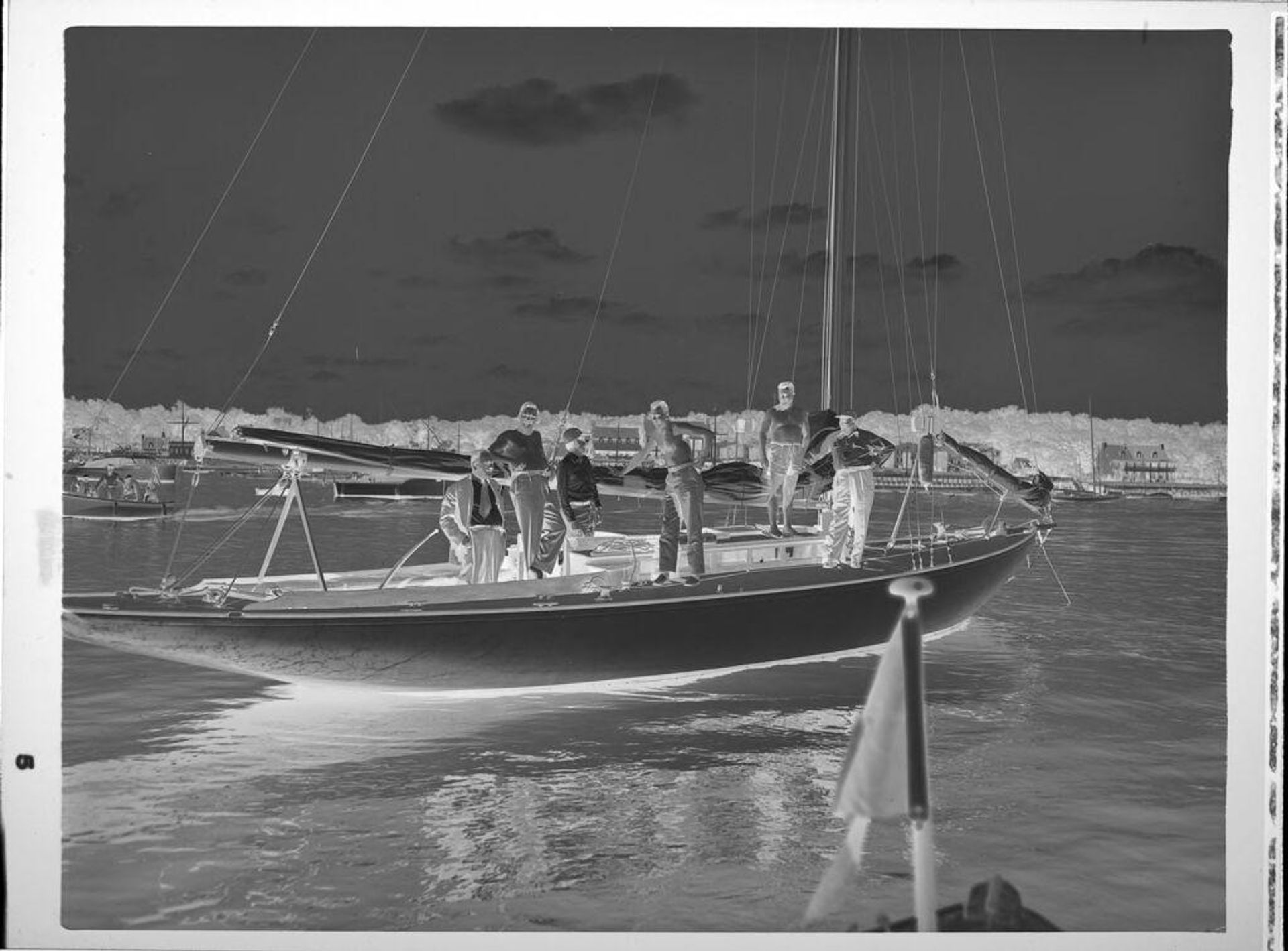 Untitled (men on sailboat) by Peter James Studio