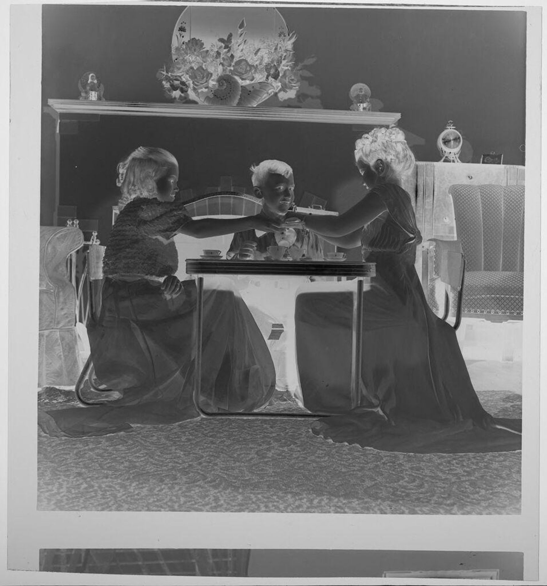 Untitled (two girls and a boy having a tea party) by Jack Gould