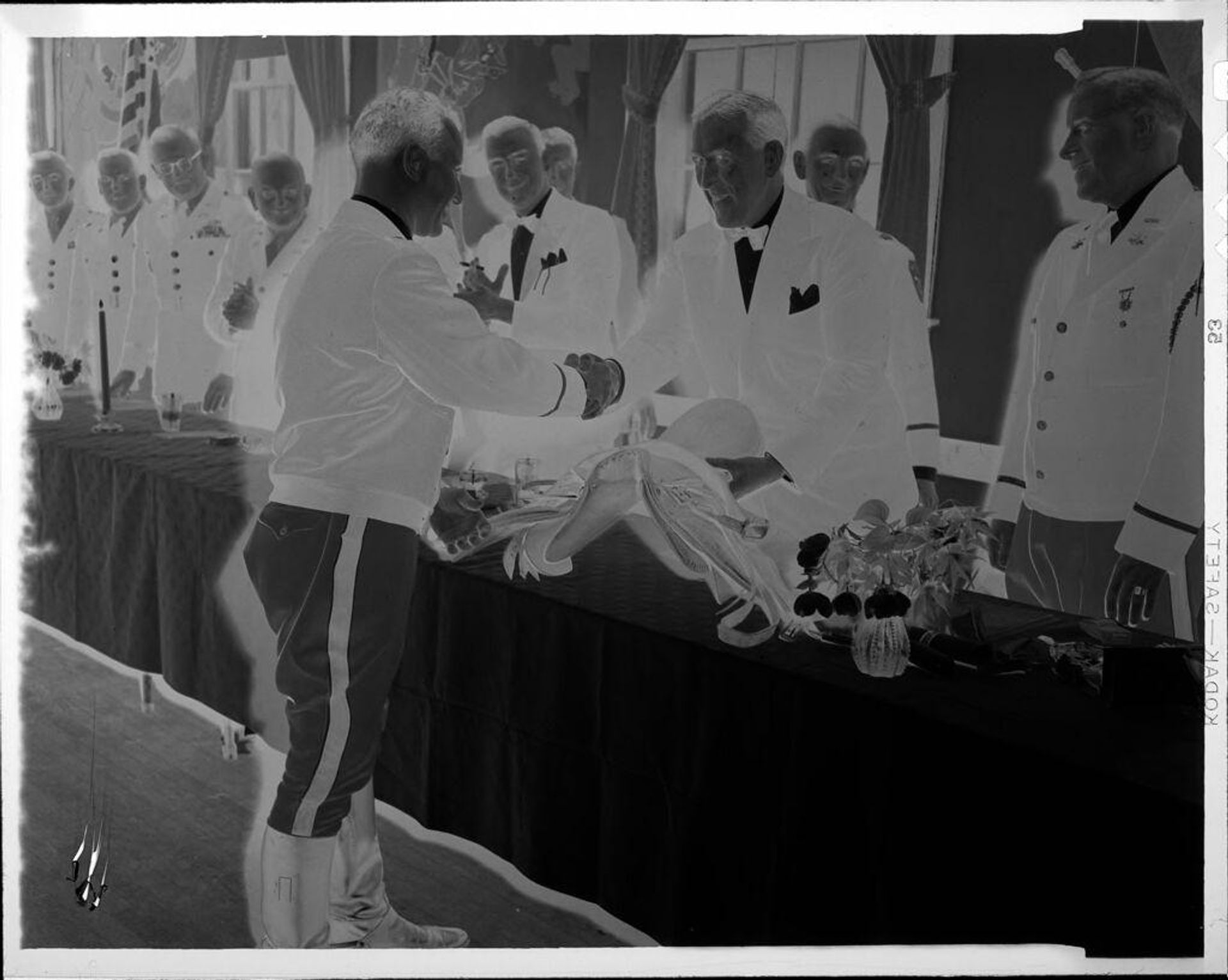 Untitled (men shaking hands across long table) by Robert Burian